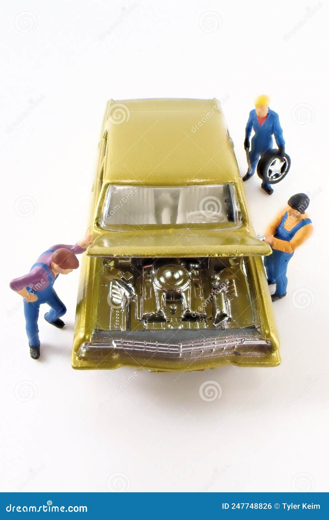 Wallpaper #2WfT-5IBSpphPi3-epWx43 Miniature Mechanics Work on a Gold Toy Car Stock Photo Image of