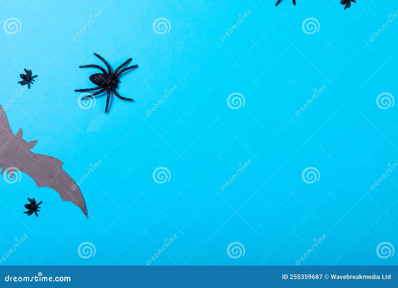 Wallpaper #GfQnOpMBKFX8bn3r3Xh8356 Multiple Spider and Bat Toys with Copy Space on Blue Background Stock