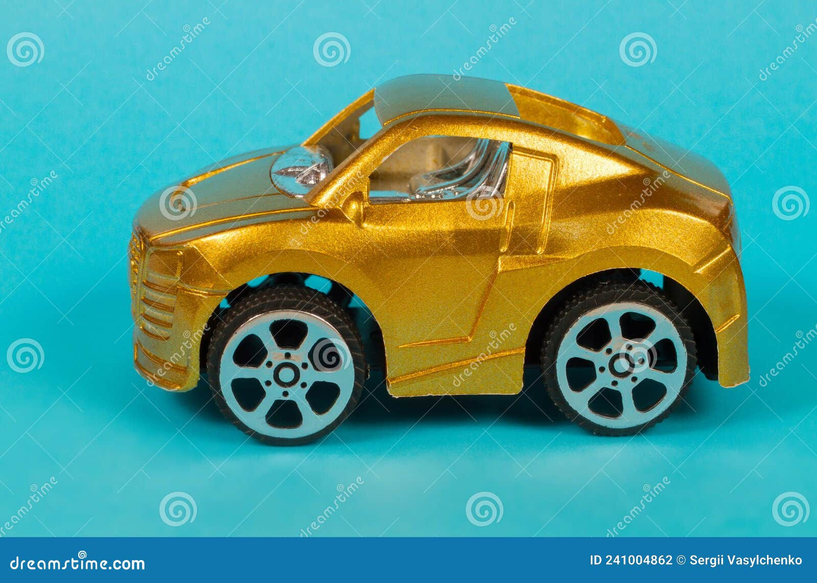 Wallpaper #0GfJ9pIBSpphPi3-OYTp79 A Toy Car of Gold Color on a Blue Background Stock Photo Image of