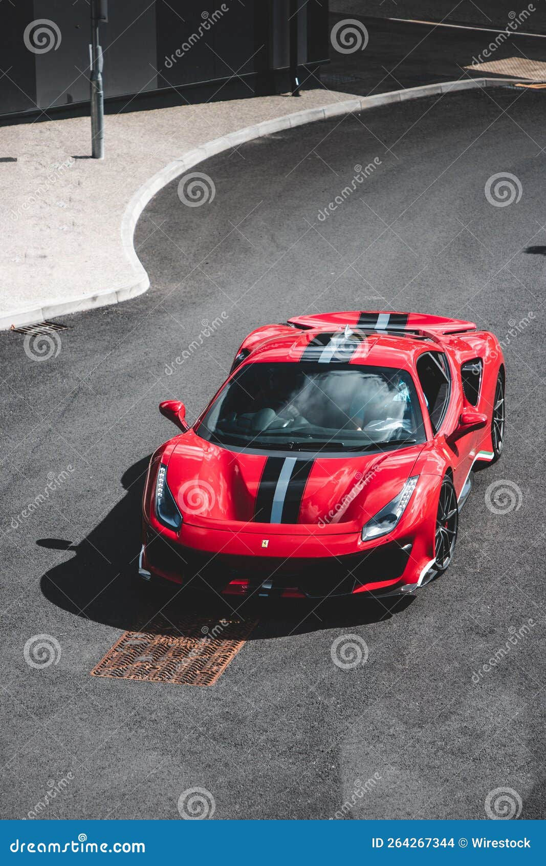Wallpaper #pBXtsY4BmMigT4UnrFFi28 Vertical of a Red Ferrari with Black Stripes Captured from a Top View