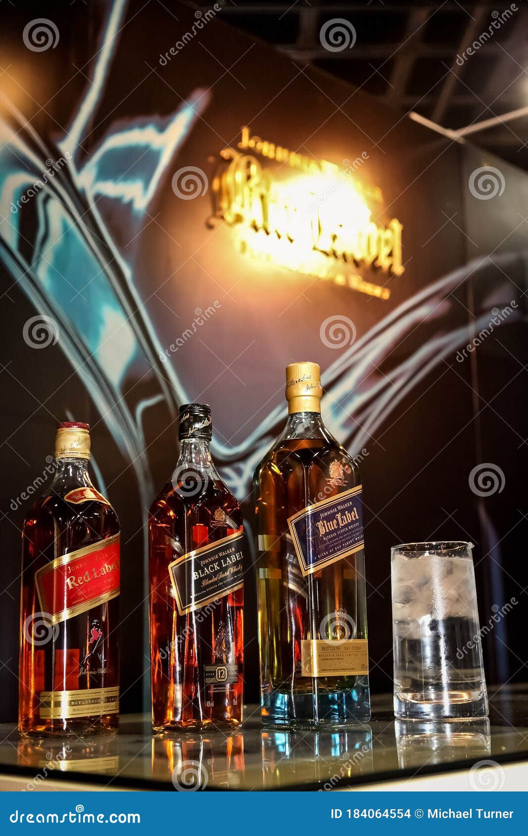 Wallpaper #MupXVZMBlwTYPL18cw3v128 Johnnie Walker Red Black and Blue Bottles on Bar Counter Top Editorial