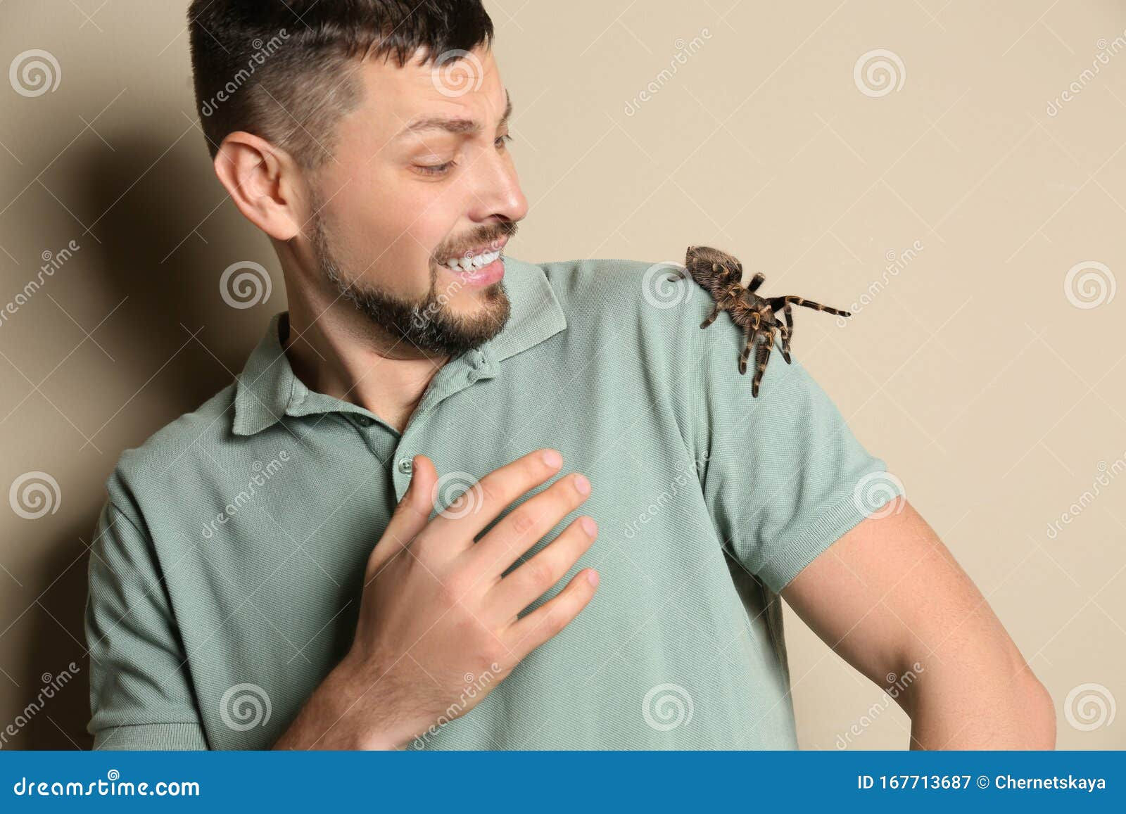 Wallpaper #KBmFDo8BtGB6xQ78G1oC52 Scared Man with Tarantula on Background Arachnophobia Fear of Spiders