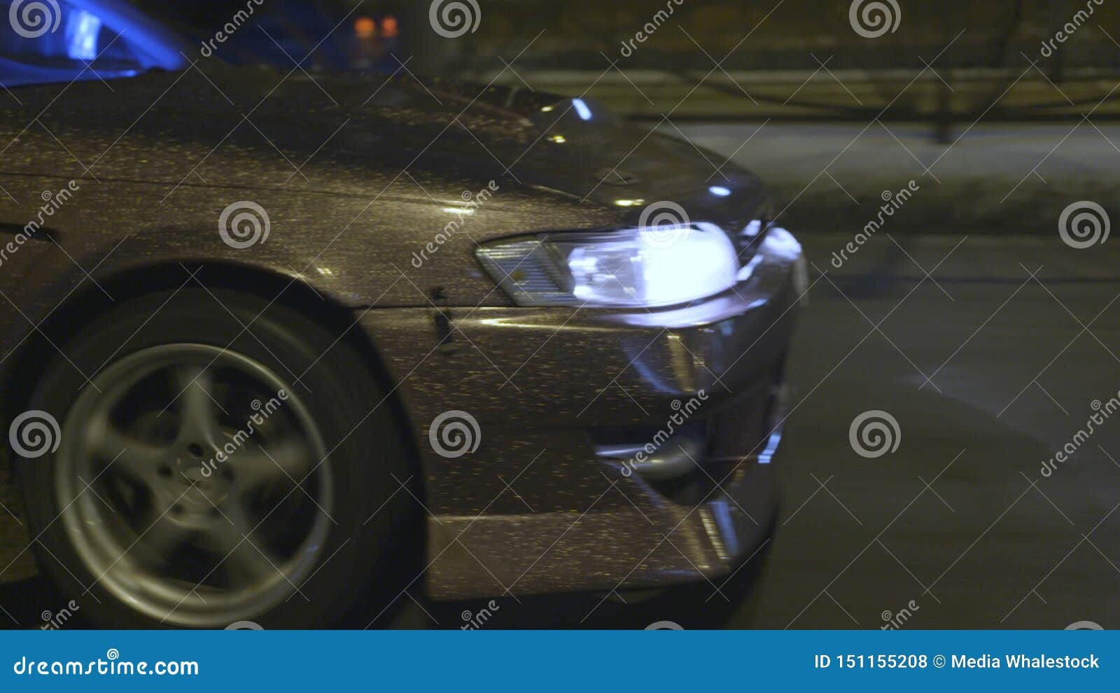 Wallpaper #kWidIpMBSpphPi3-uDN4322 Side View of a Car Driving Along the Road Headlights Illuminating the