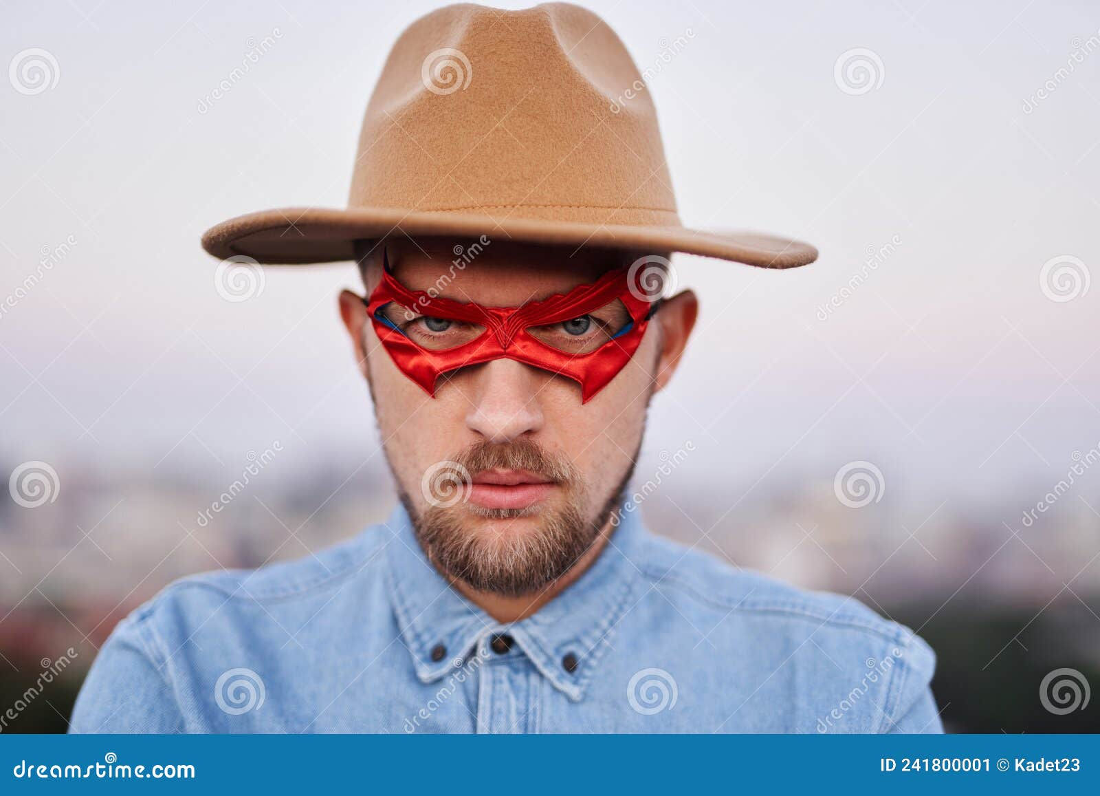 Wallpaper #m2fSBJMBSpphPi3-n7nR76 Serious Man in Superhero Red Mask and Hat with Urban View Stock Image