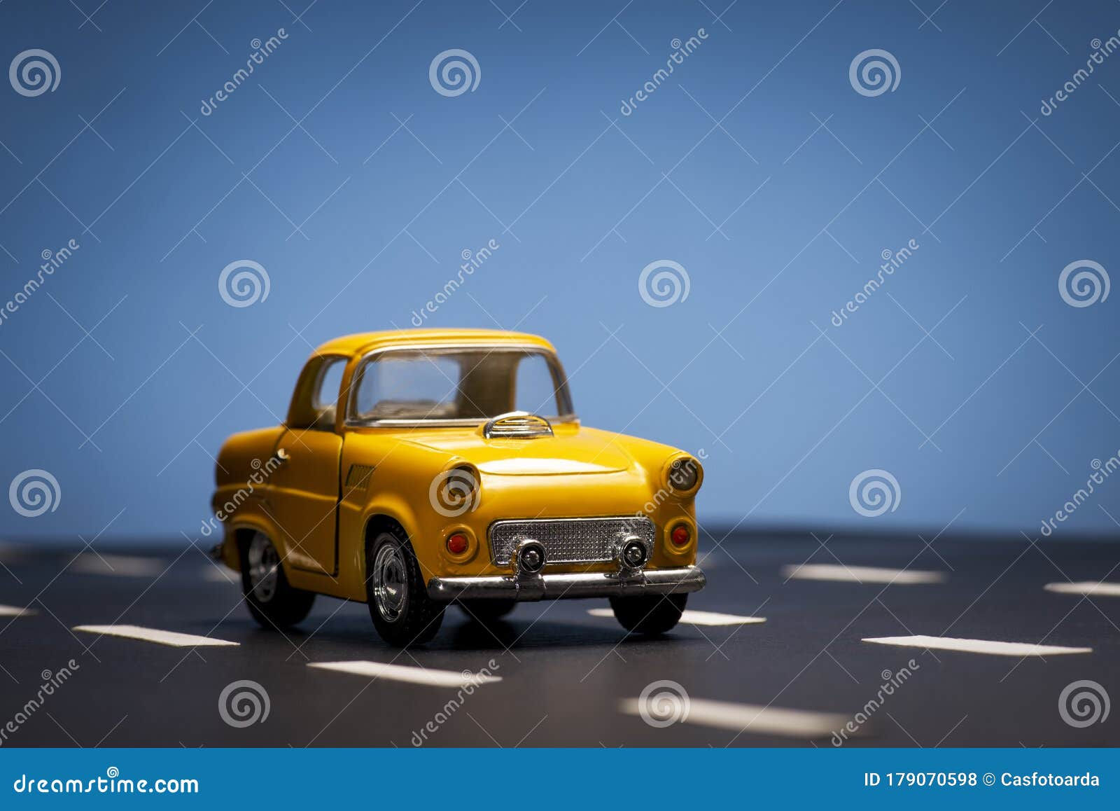 Wallpaper #0GfJ9pIBSpphPi3-OYTp285 Yellow Toy Car on a Blue Background Stock Photo Image of Highway