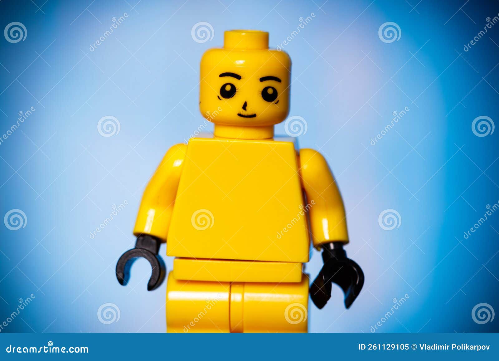 Wallpaper #tmiSGZMBSpphPi3-zxdm272 Yellow Lego Figure with a Smile on His Face on a Blue Background with a