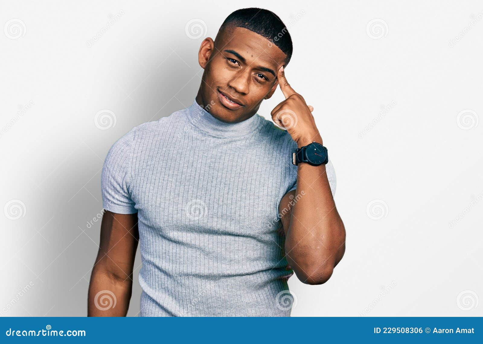 Wallpaper #IWf6_JIBSpphPi3-lZoB33 Young Black Man Wearing Casual T Shirt Smiling Pointing to Head with
