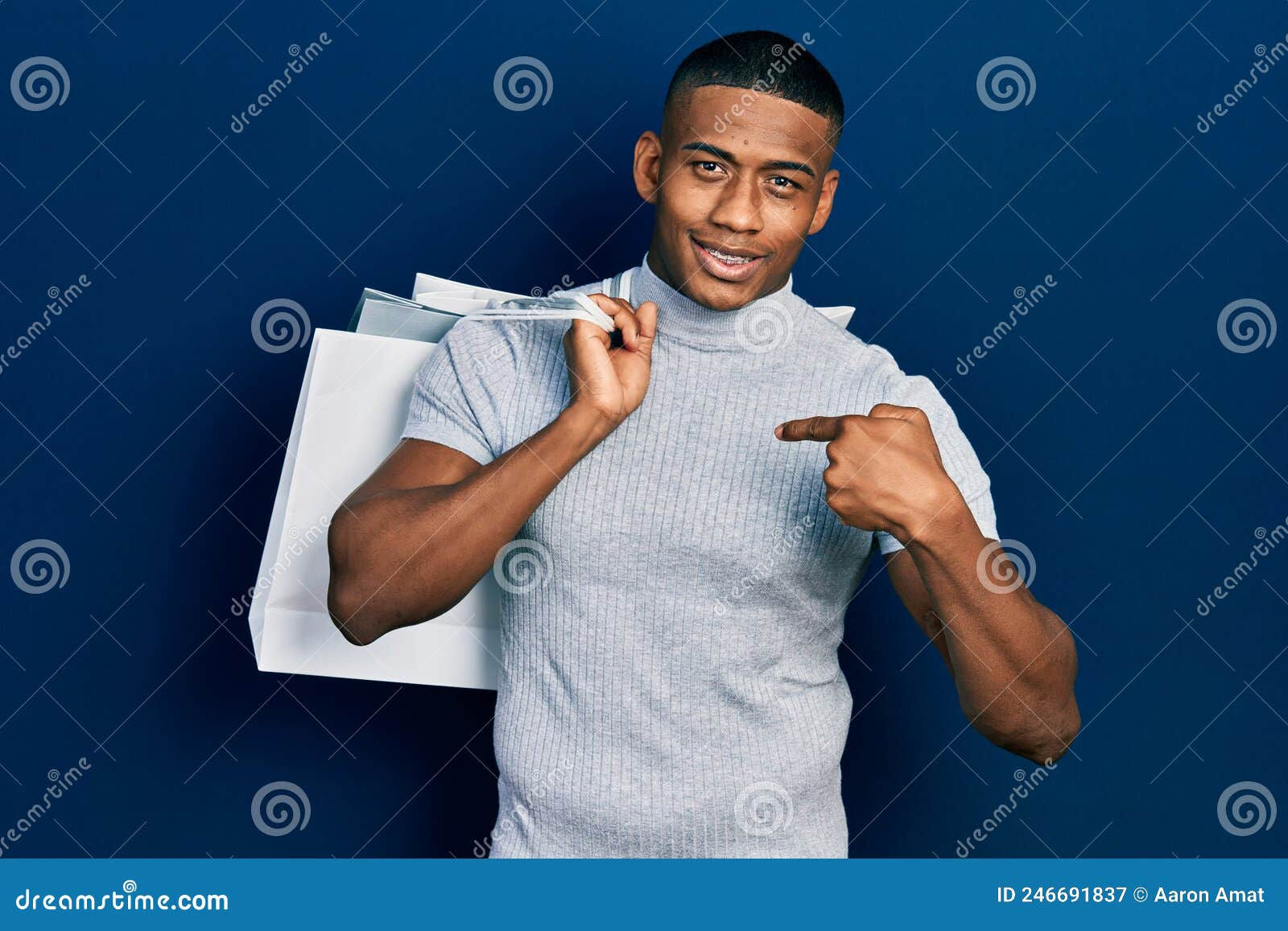 Wallpaper #IWf6_JIBSpphPi3-lZoB257 Young Black Man Holding Shopping Bags Pointing Finger to One Self