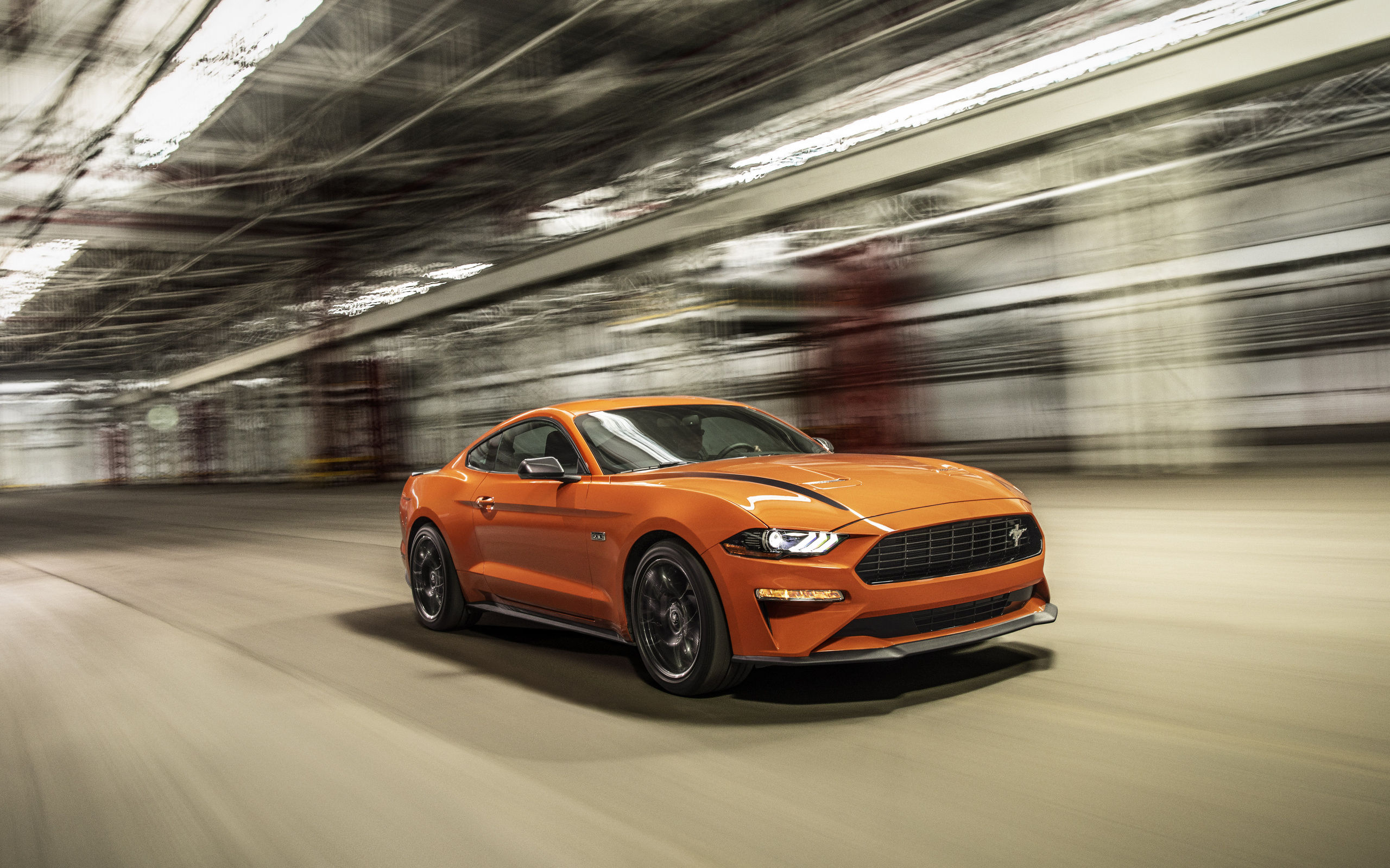 Wallpaper #_kWjoY4B7YBJg1BVvqN832 A Sleek Orange Ford Mustang GT Drives Through a Tunnel