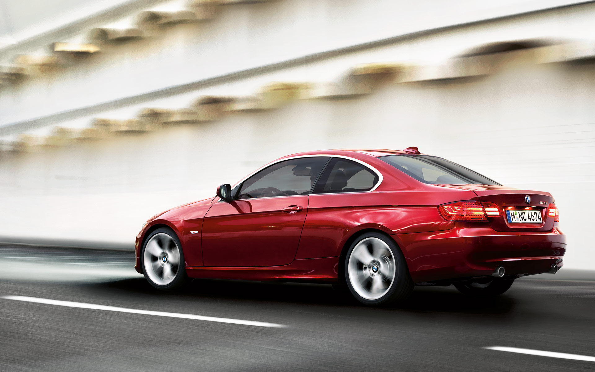 Wallpaper #lUW_oo4B7YBJg1BVBqSA32 A Red BMW 3-Series Coupe Drives on an Asphalt Road