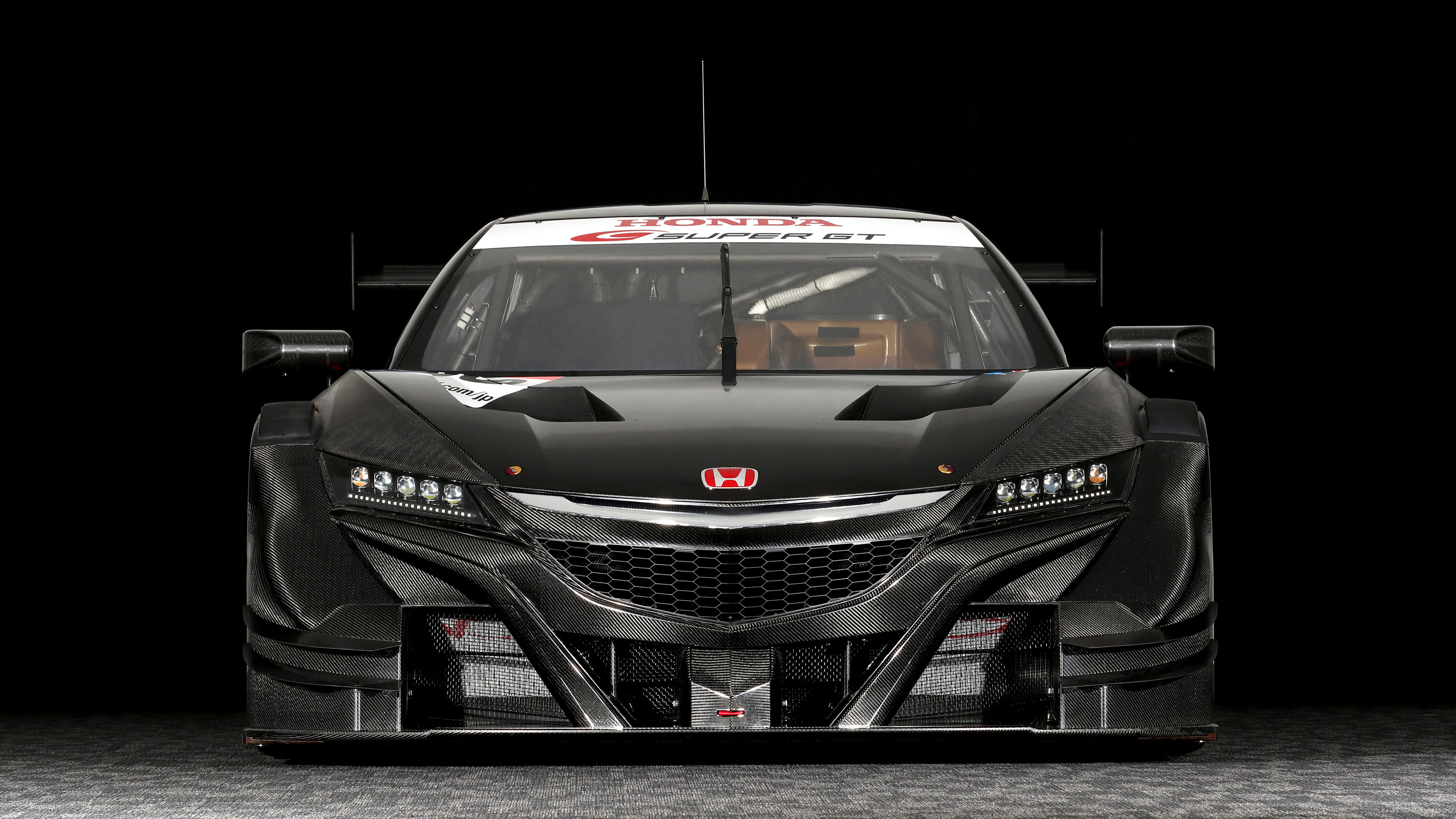 Wallpaper #r0U0l44B7YBJg1BVZKDq19 A Black and Red Race Car with the Word "honda" on the Hood