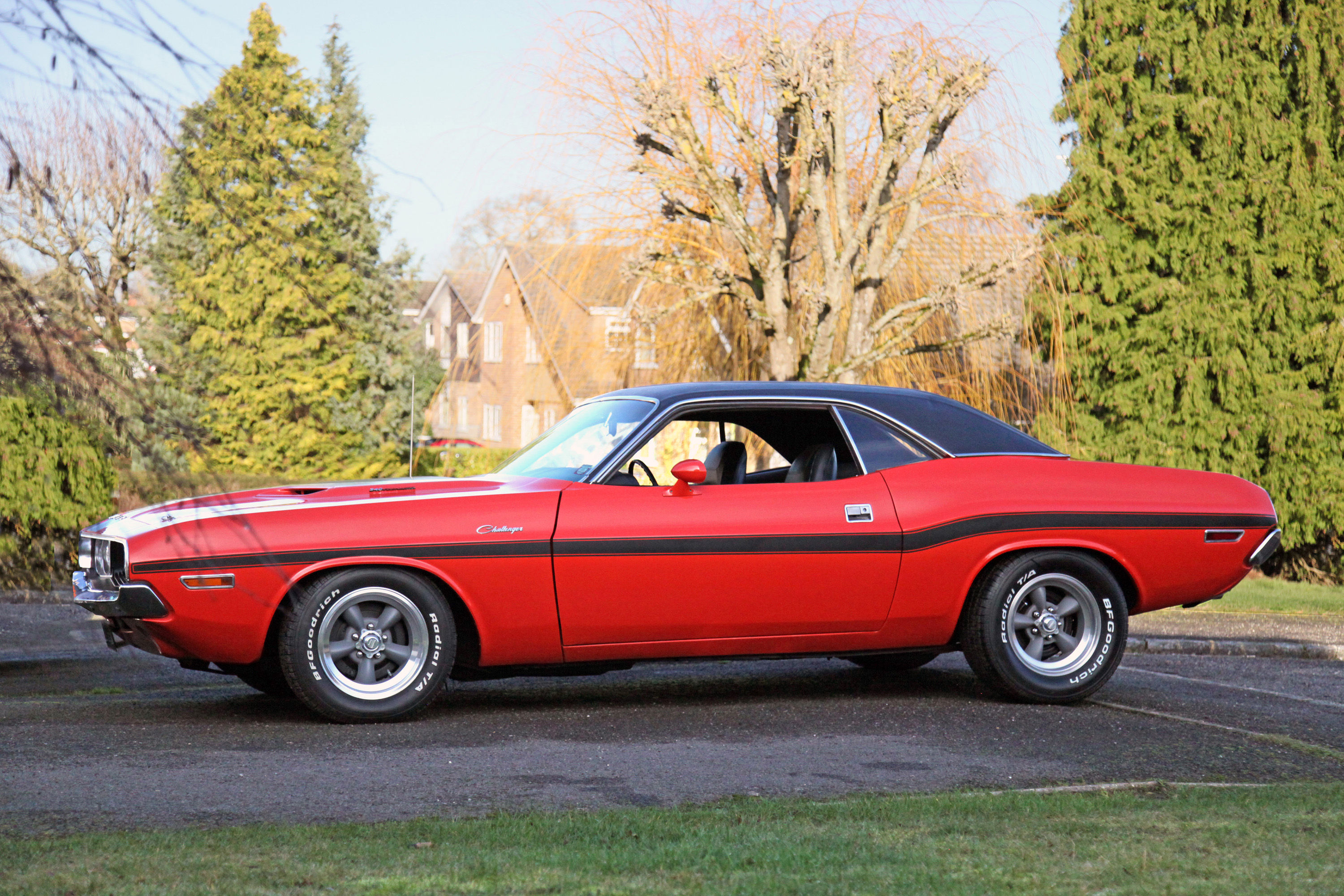 Wallpaper #ZHMQg44BFI5NbQks_xk228 A Red 1970 Dodge Challenger Parked on a Tree-Lined Street