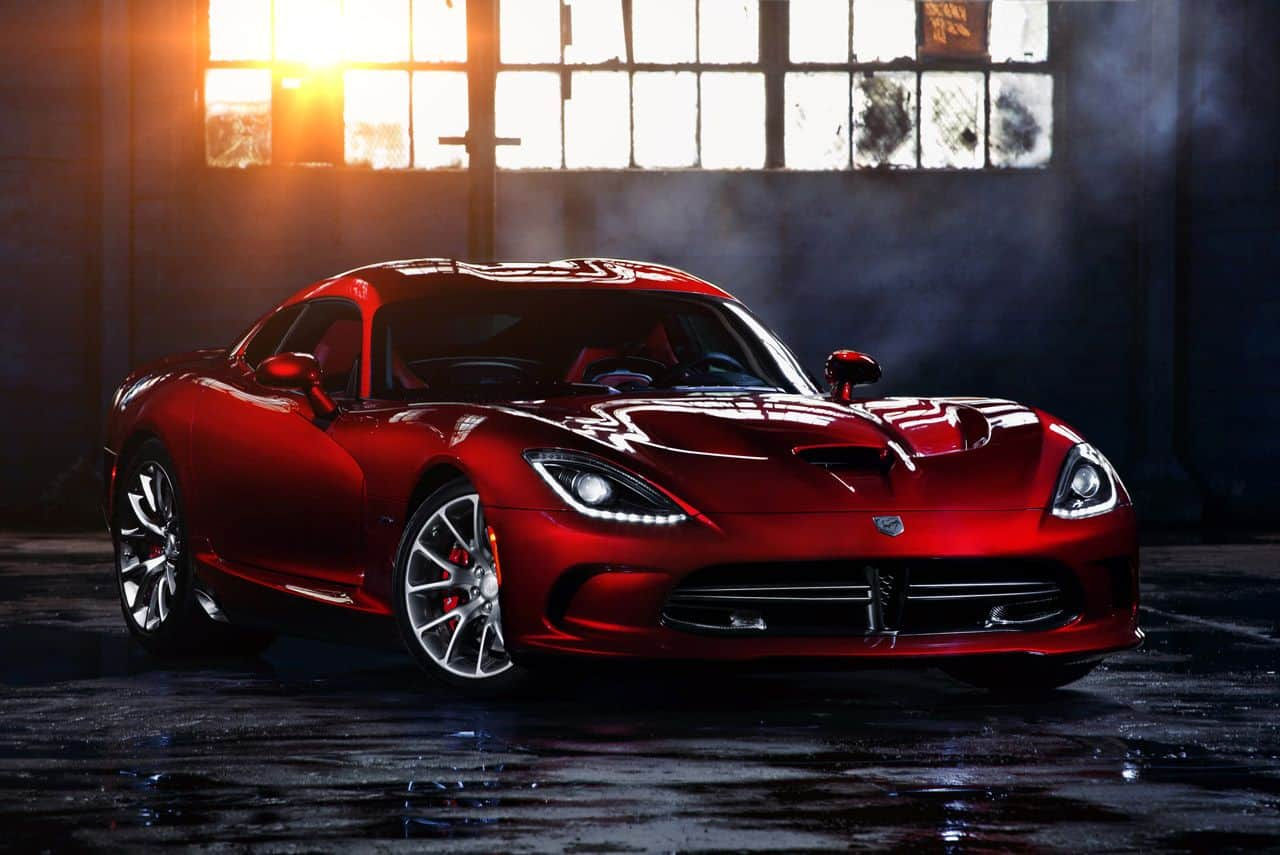 Wallpaper #-BWPso4BmMigT4UnP1FC24 A Red Dodge Viper Parked in a Dark Garage