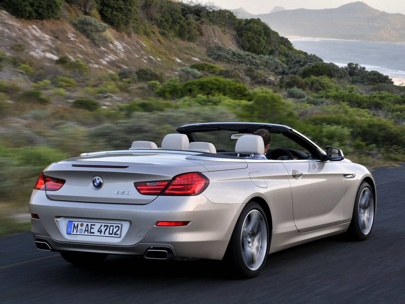 Wallpaper #VkVolo4B7YBJg1BVLqAC59 A Silver BMW 6 Series Convertible Driving on a Coastal Road