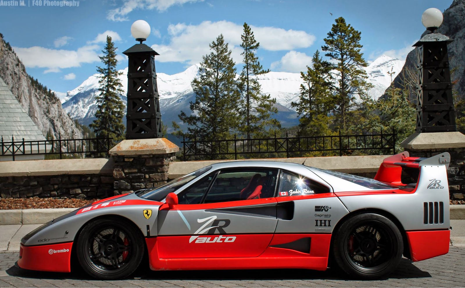 Wallpaper #K3OBh44BFI5NbQksaSEI58 A Sleek Red and Silver Sports Car Parked in Front of a Majestic Mountain Range