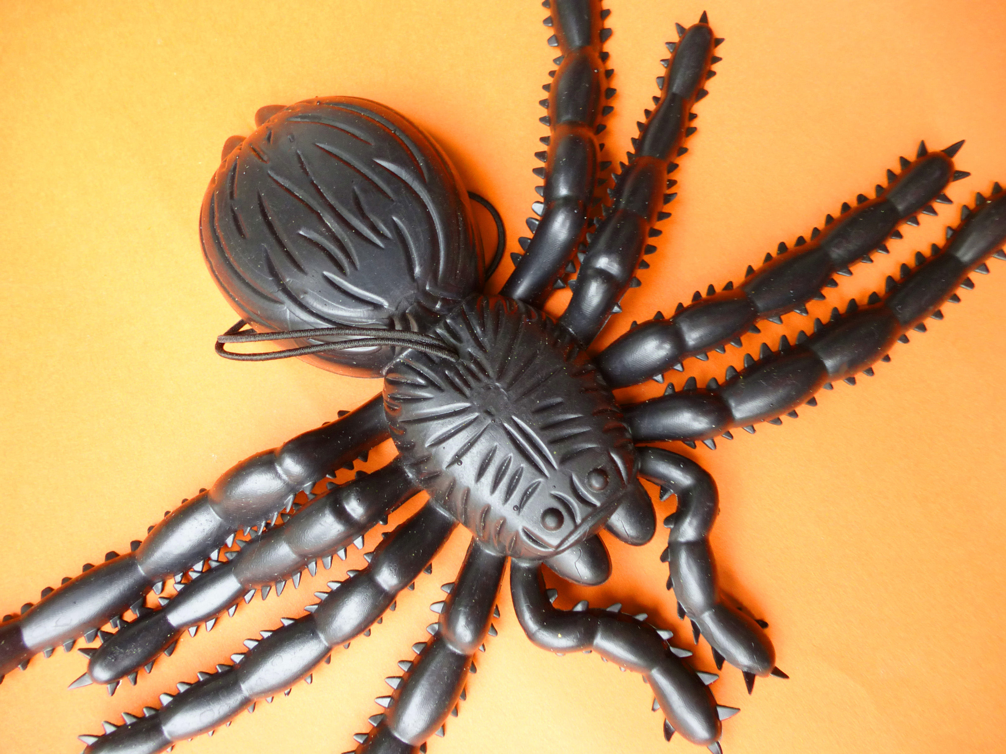 Wallpaper #1fQOOpMBKFX8bn3r-3cr51 Image of Plastic Spider Toy on Orange Background Creepyhalloweenimages