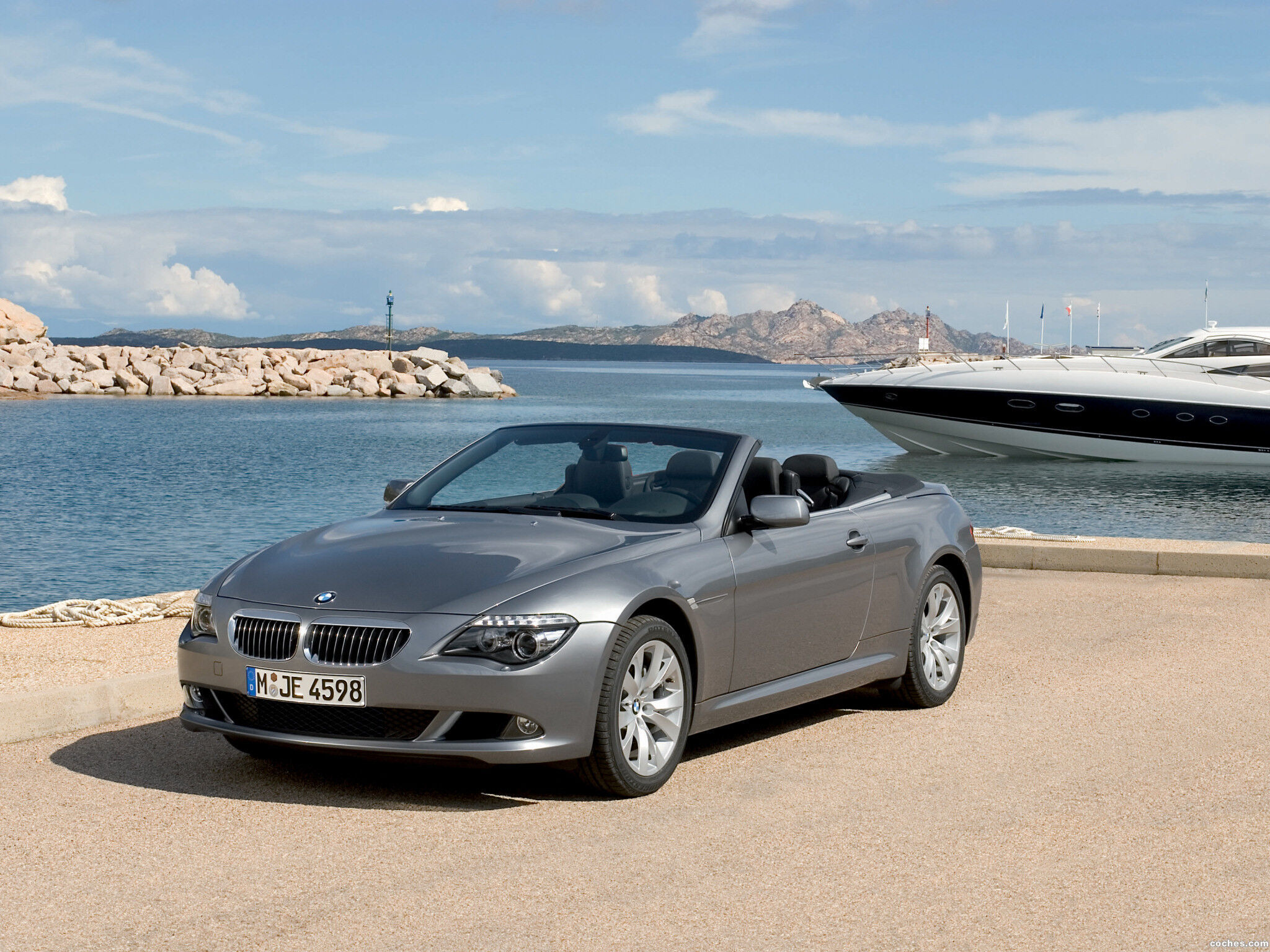 Wallpaper #VkVolo4B7YBJg1BVLqAC52 A Silver BMW 6-Series Convertible Parked on a Pier with the Ocean in the Background