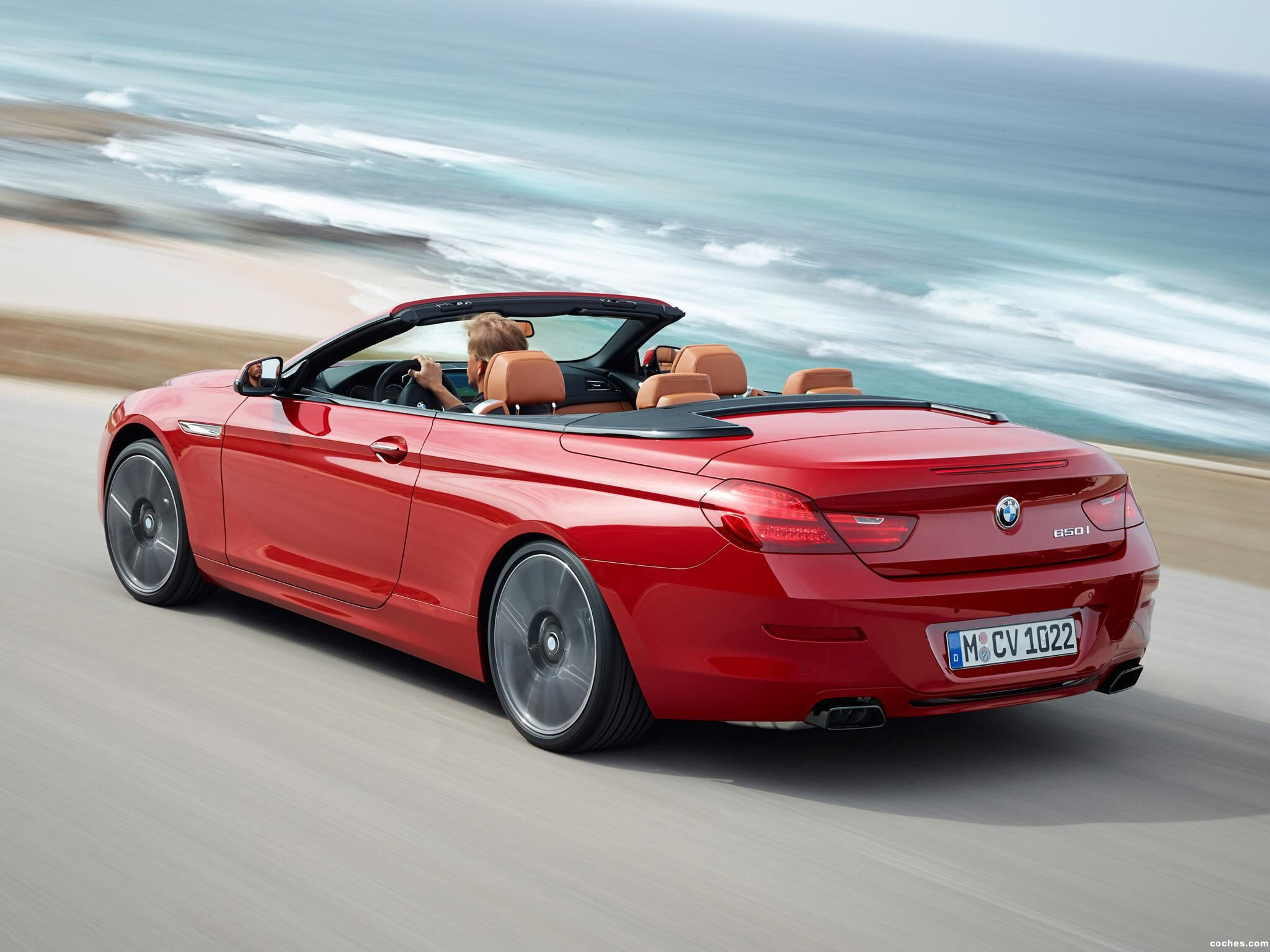 Wallpaper #VkVolo4B7YBJg1BVLqAC33 A Red BMW 6 Series Convertible Driving on a Coastal Road