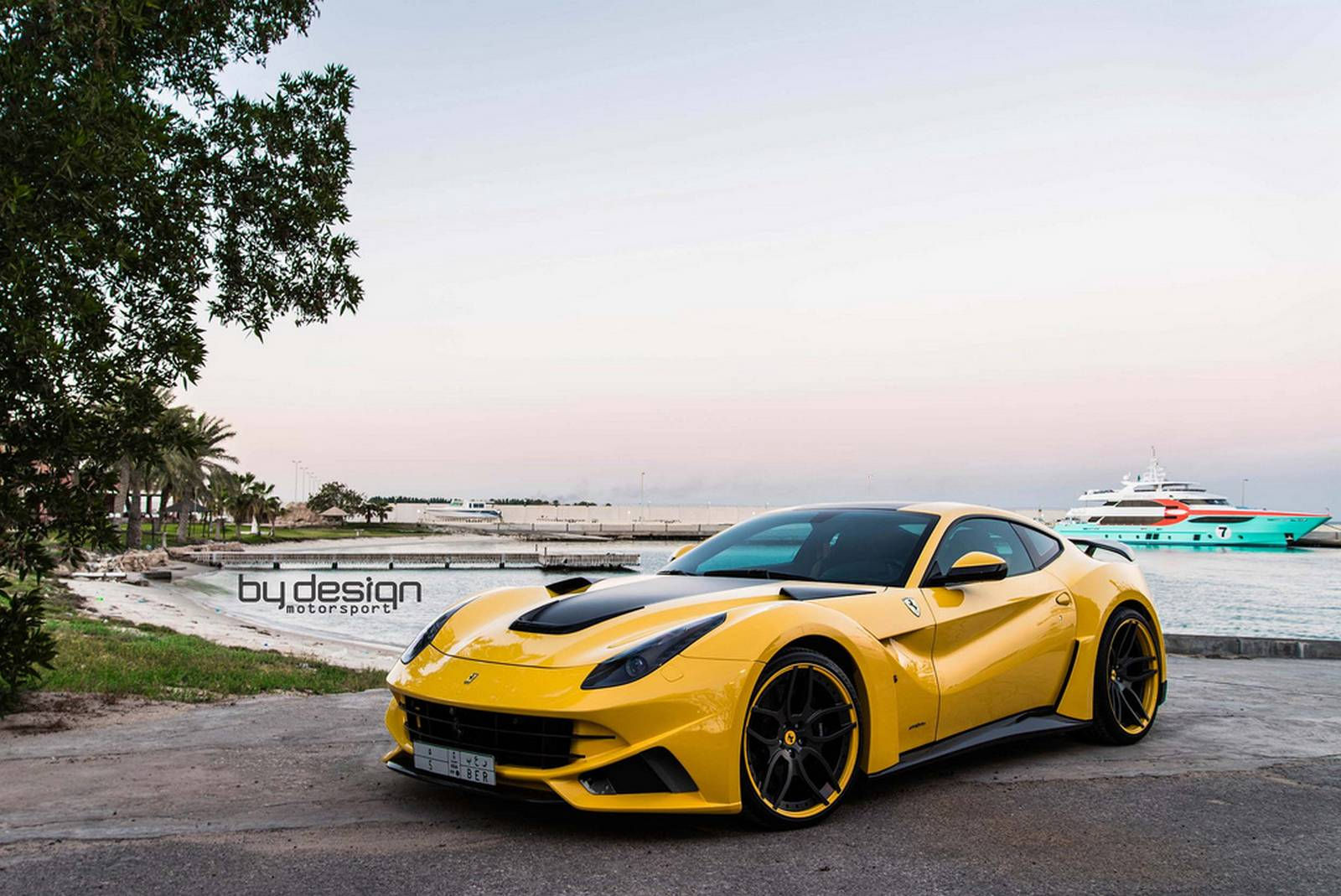 Wallpaper #3UUMm44B7YBJg1BVsKG014 Yellow Ferrari F12 Berlinetta Parked on a Beach