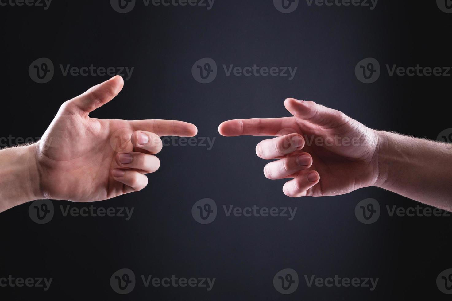 Wallpaper #1Gc0CJMBSpphPi3-gckF72 Two Mens Hands Point at Each Other with Index Fingers the Concept of