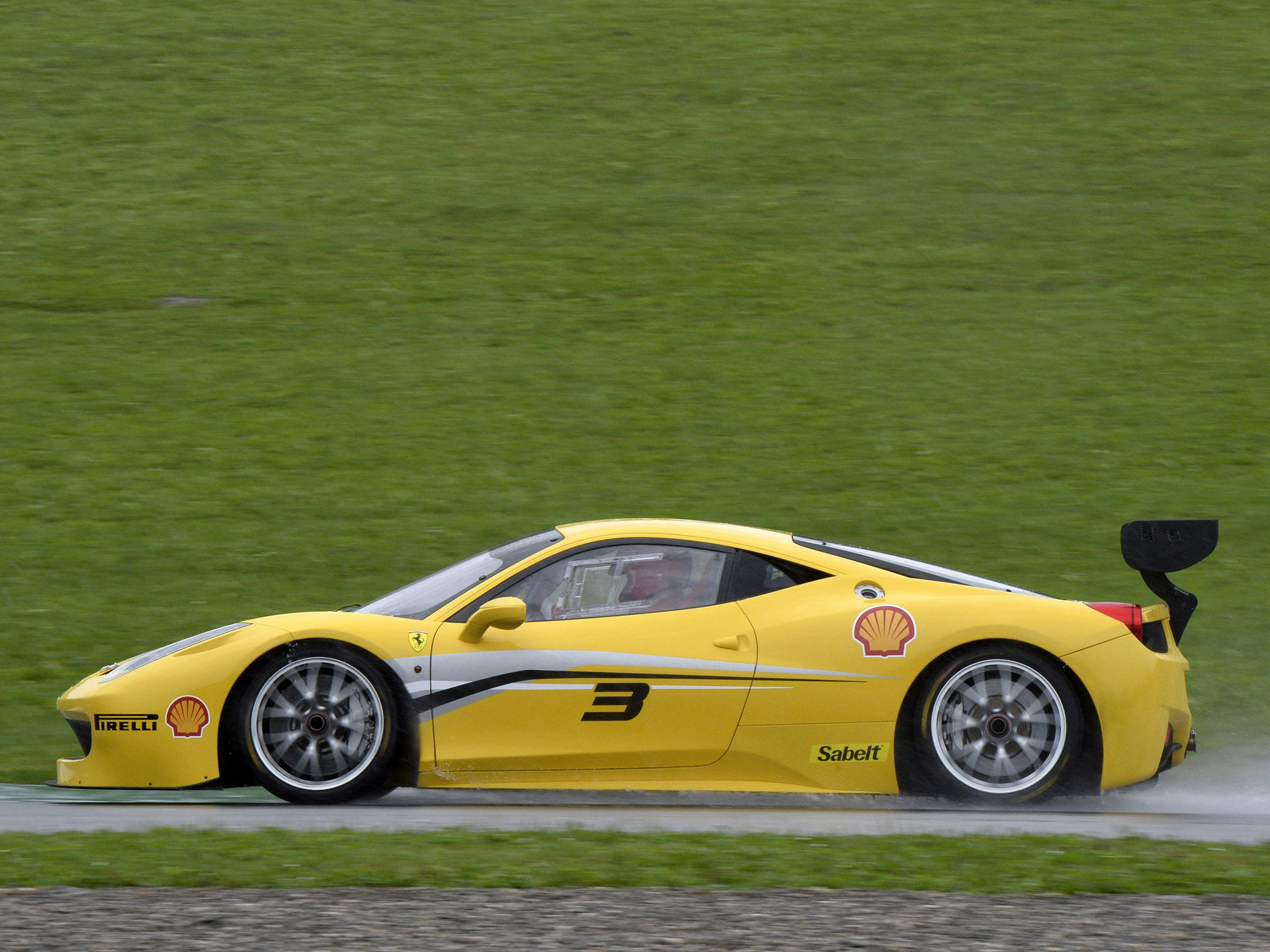 Wallpaper #53NJh44BFI5NbQkspCDD39 Yellow Ferrari Race Car Speeding Around a Green Racetrack