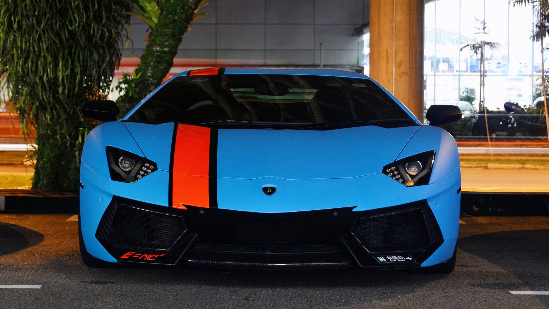 Wallpaper #0nP5hY4BFI5NbQksux4v55 A Blue Lamborghini Aventador with an Orange Racing Stripe