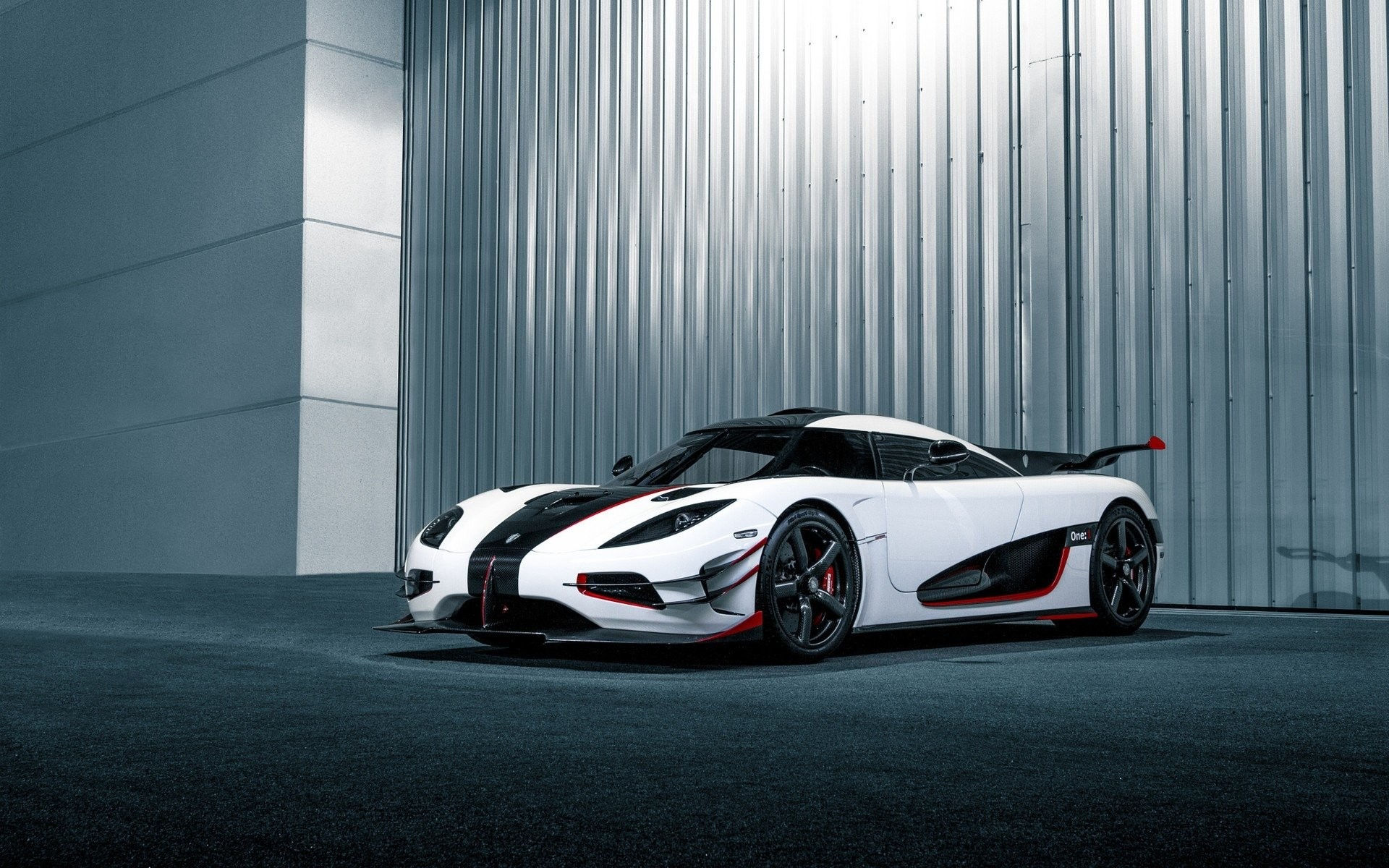 Wallpaper #0nP5hY4BFI5NbQksux4v3 A White and Black Koenigsegg Regera Parked in Front of a Corrugated Metal Wall