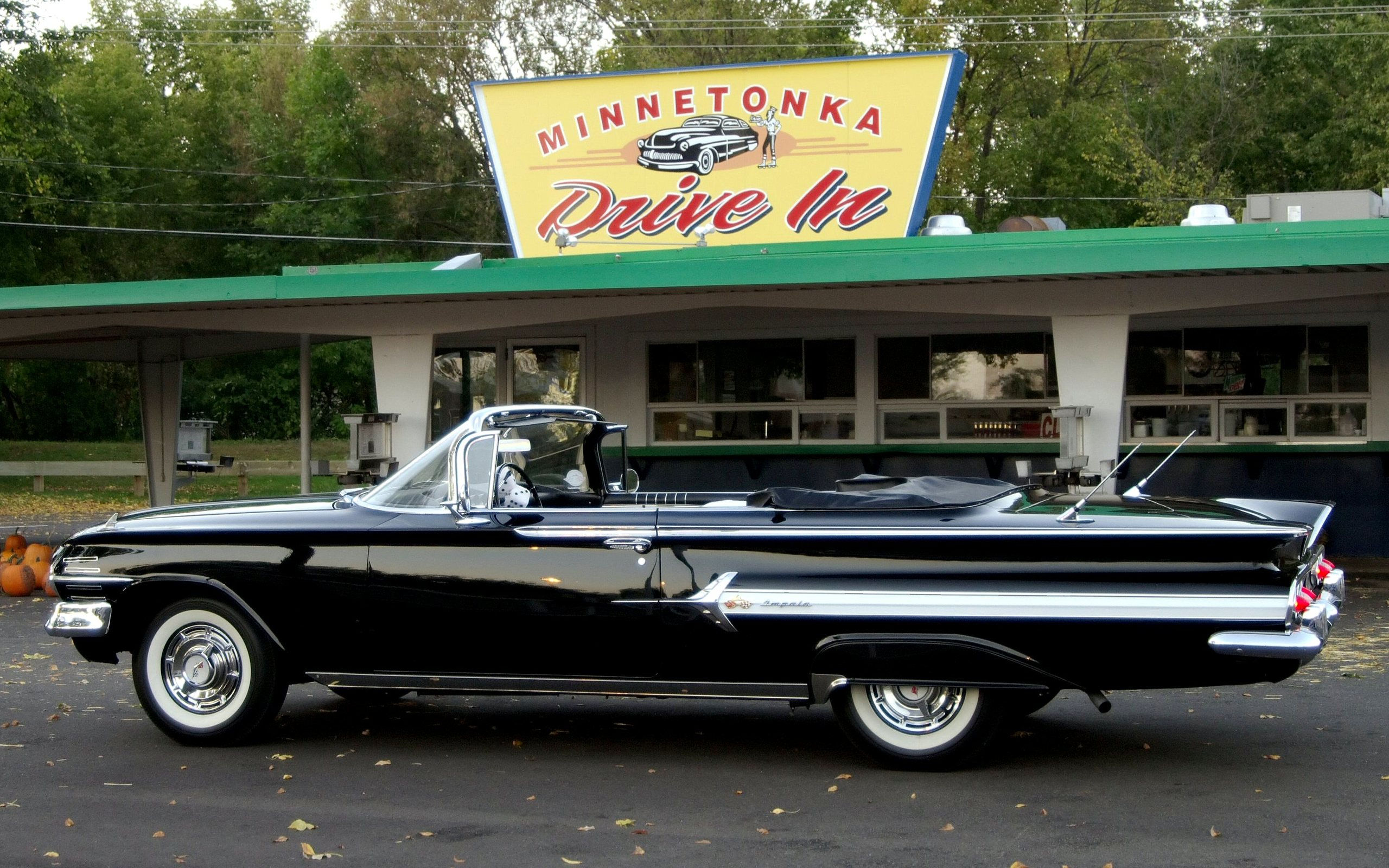 Wallpaper #_3MOho4BFI5NbQksfx5p57 A Classic Black Impala Convertible Parked in Front of a Vintage Drive-In Restaurant