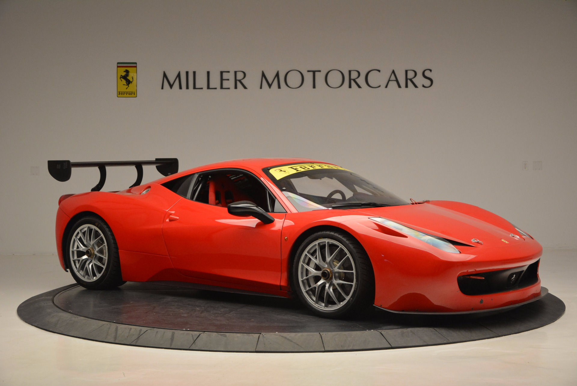Wallpaper #53NJh44BFI5NbQkspCDD16 Red Ferrari 458 Challenge Race Car with Large Rear Wing in a Studio