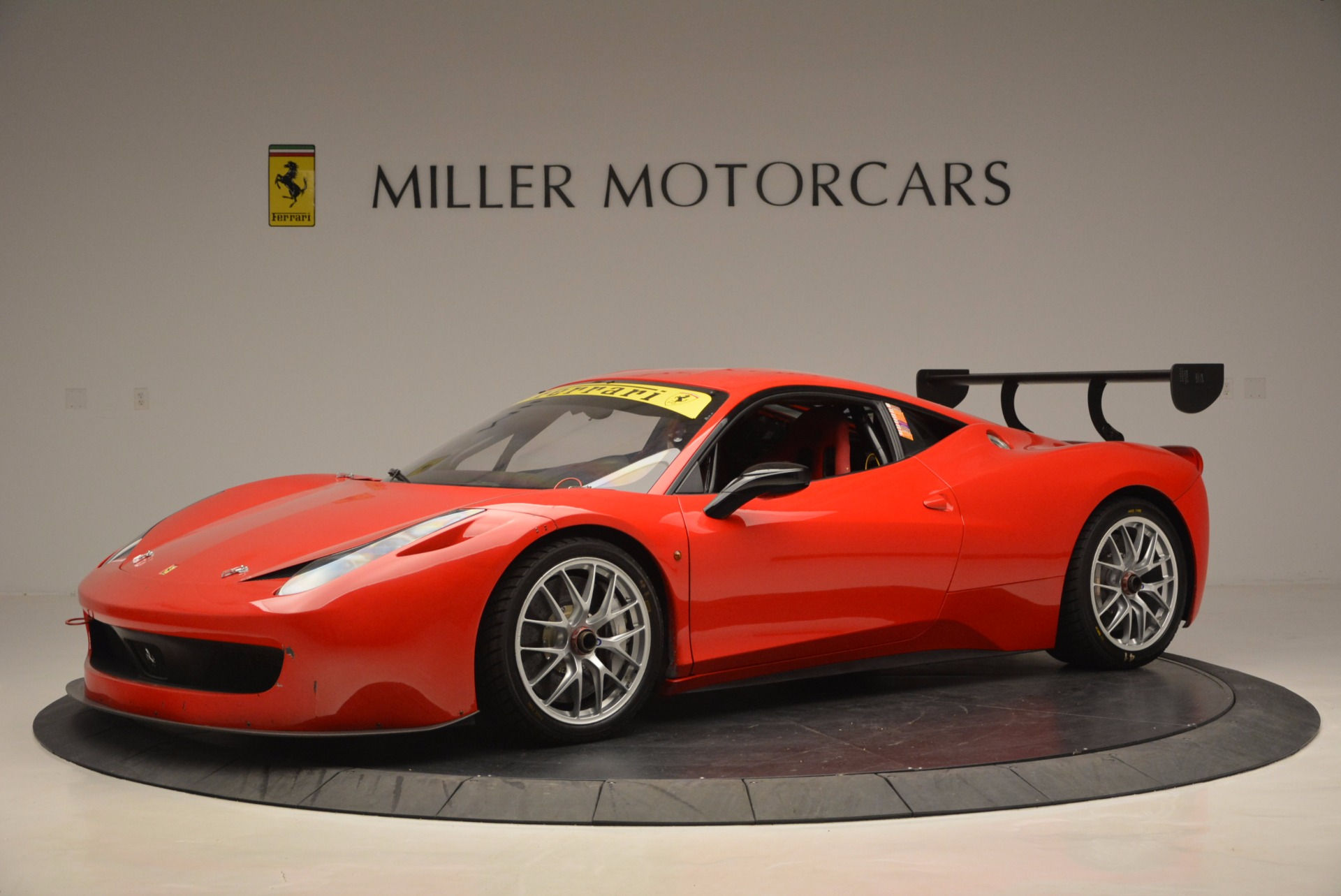 Wallpaper #53NJh44BFI5NbQkspCDD24 Red Ferrari 458 Challenge Race Car with Large Rear Wing in Showroom