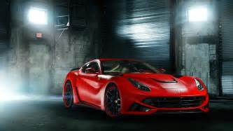 Wallpaper #YnP0fo4BFI5NbQksIxfN55 A Sleek Red Sports Car Parked in a Dark Garage