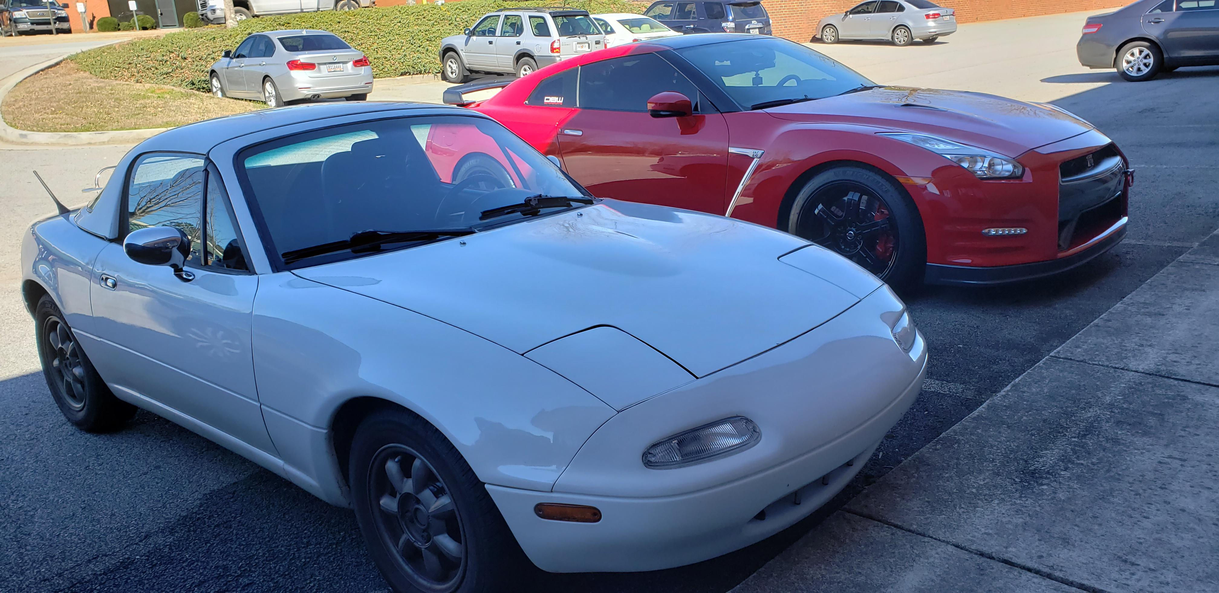 Wallpaper #NRm3Mo8BtGB6xQ782pjS17 White Mazda Miata Next to Red Nissan  GTR