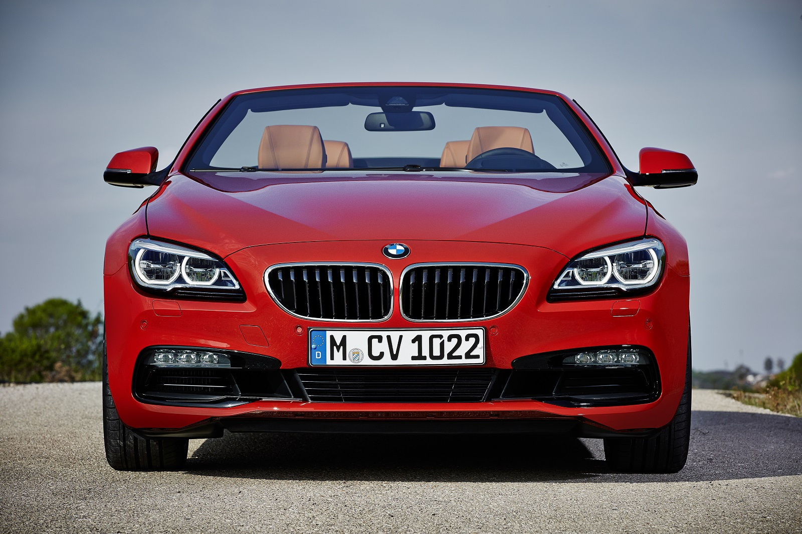 Wallpaper #VkVolo4B7YBJg1BVLqAC21 A Sleek Red BMW Convertible with the Top Down