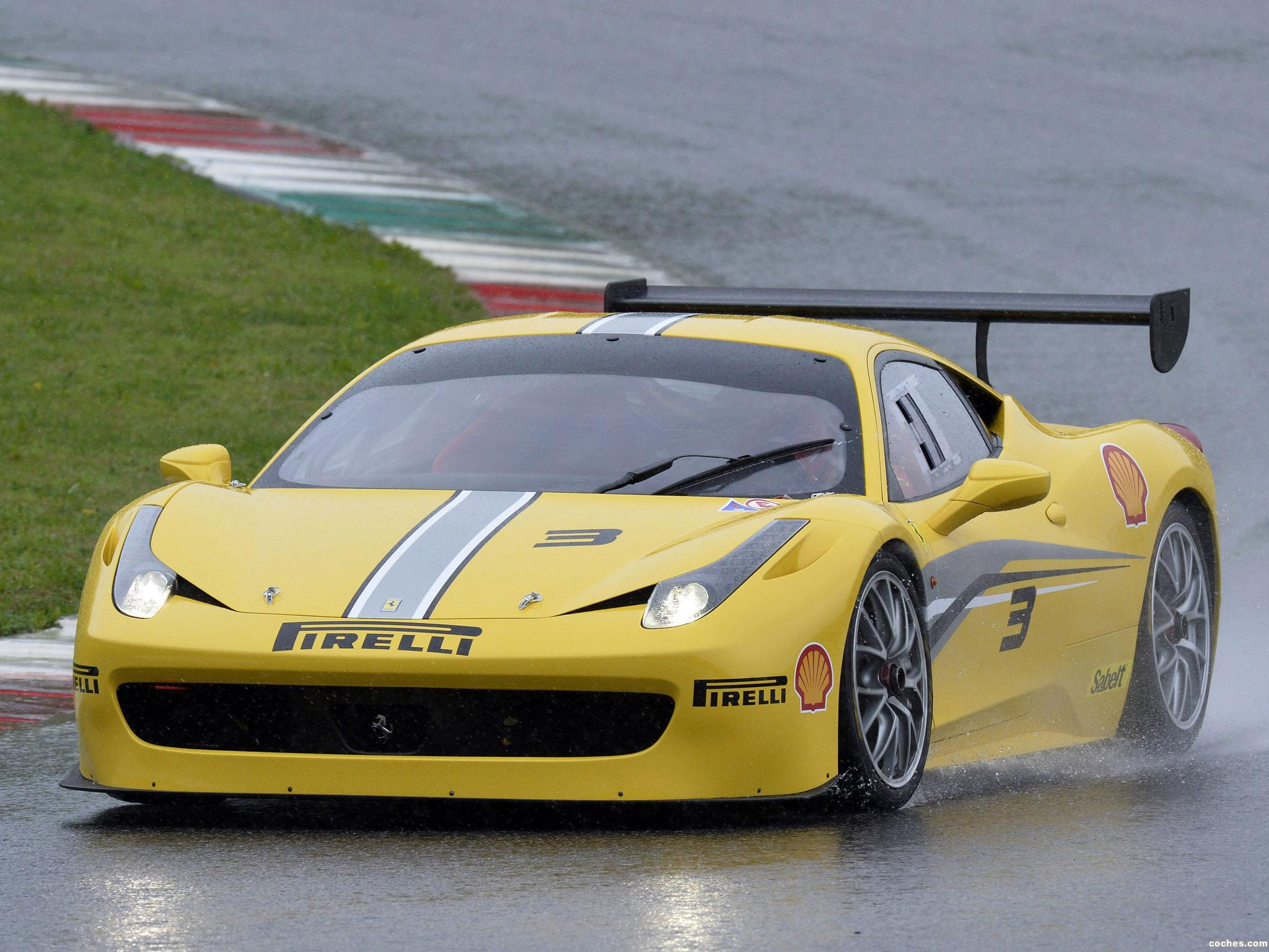 Wallpaper #53NJh44BFI5NbQkspCDD25 Yellow Ferrari Race Car Speeding Through the Rain on a Race Track