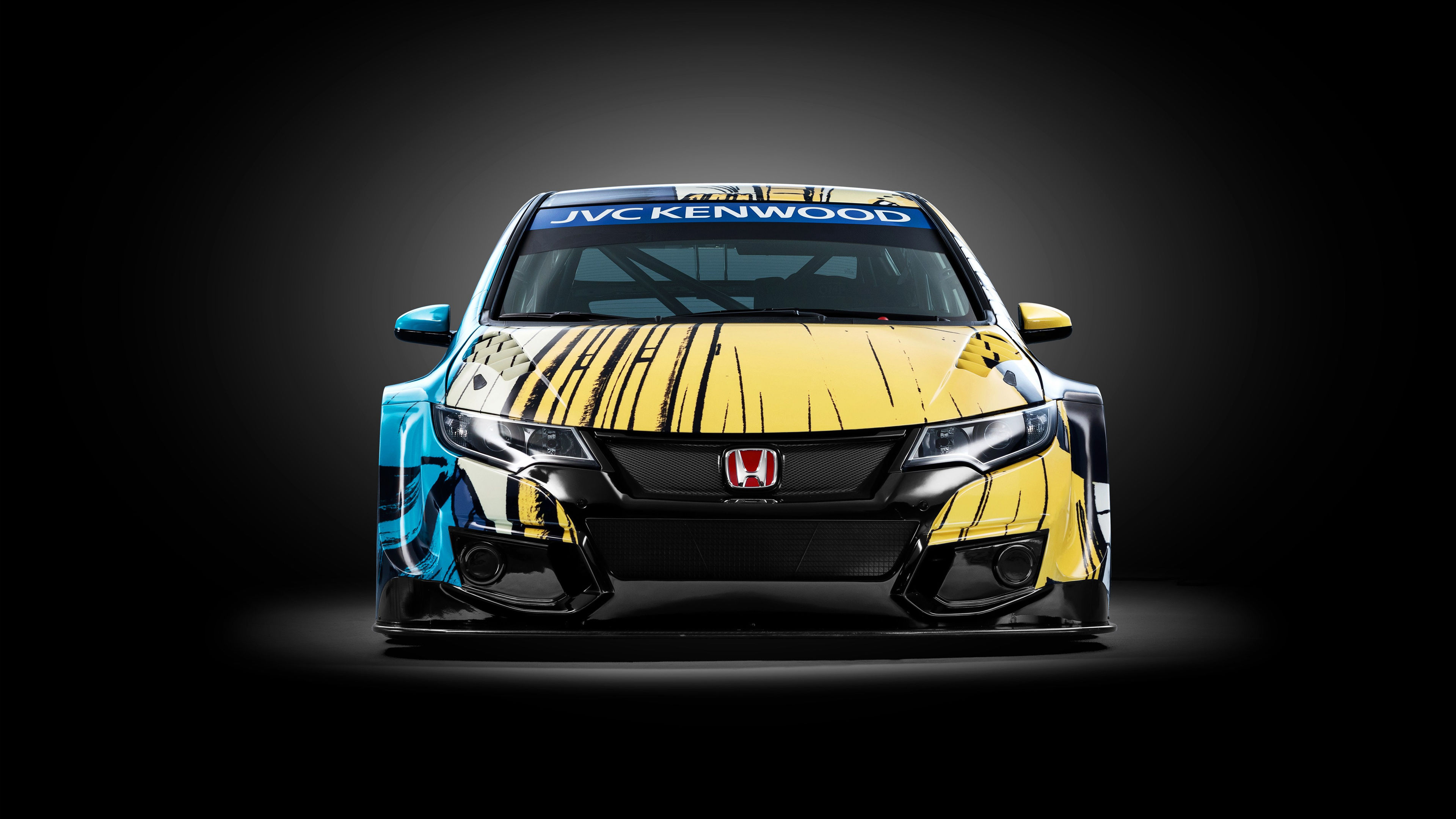 Wallpaper #r0U0l44B7YBJg1BVZKDq2 A Yellow and Blue Race Car with a Large Front Spoiler