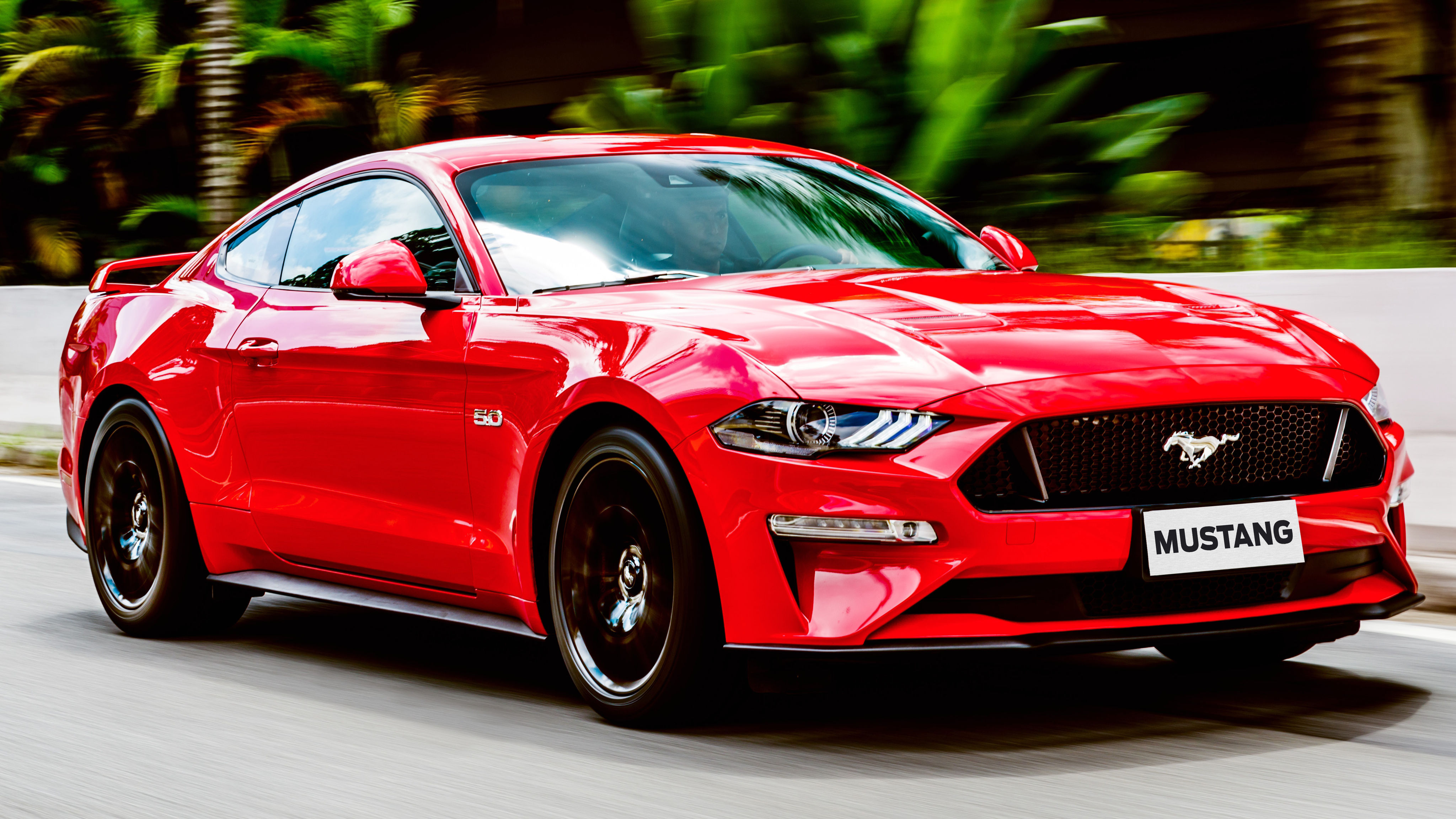 Wallpaper #vUUBm44B7YBJg1BVD6GI2 A Red Ford Mustang Driving on a Winding Road
