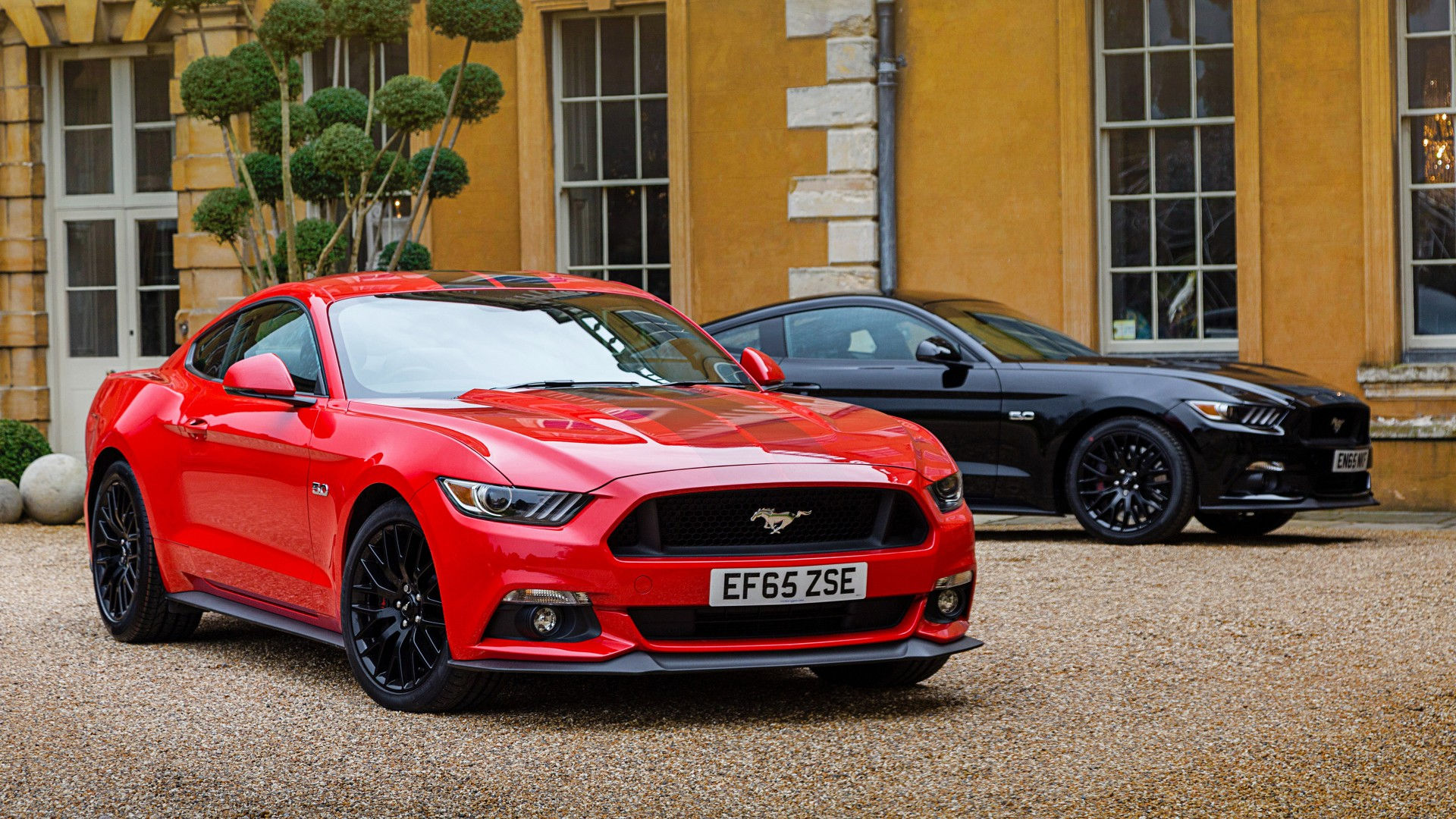 Wallpaper #nUUgl44B7YBJg1BVN6AP23 Two Ford Mustangs Parked in Front of a Stately Home