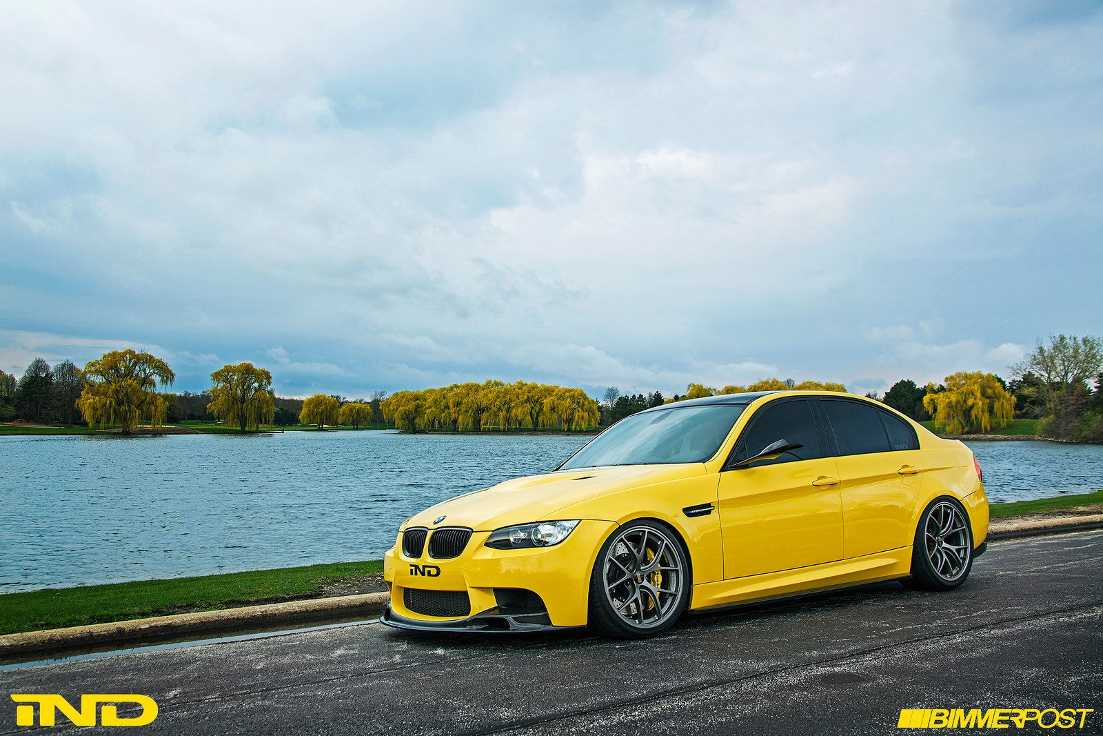 Wallpaper #gUV0lI4B7YBJg1BVKp9647 A Yellow BMW M3 Parked Next to a Lake