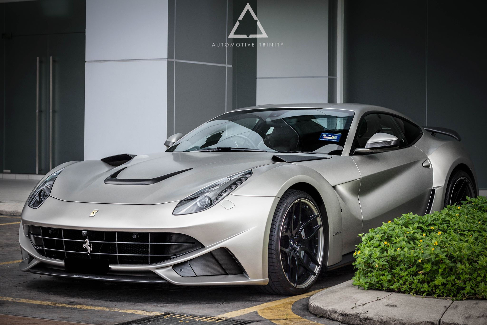 Wallpaper #3UUMm44B7YBJg1BVsKG049 A Silver Ferrari 458 Italia Parked in Front of a Building