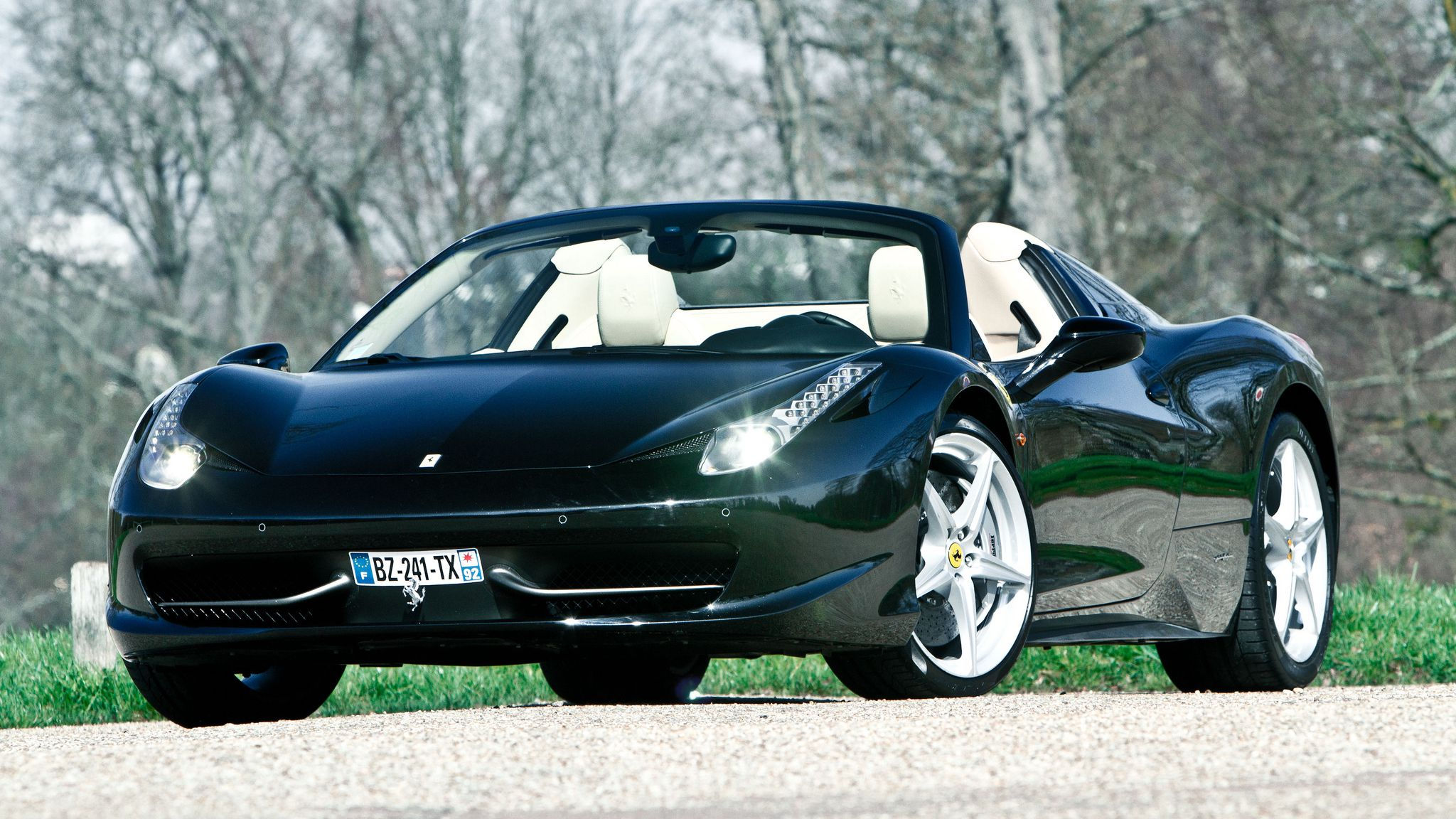 Wallpaper #0HNNiI4BFI5NbQkskCGi4 A Sleek Green Ferrari 458 Spider Parked on a Road