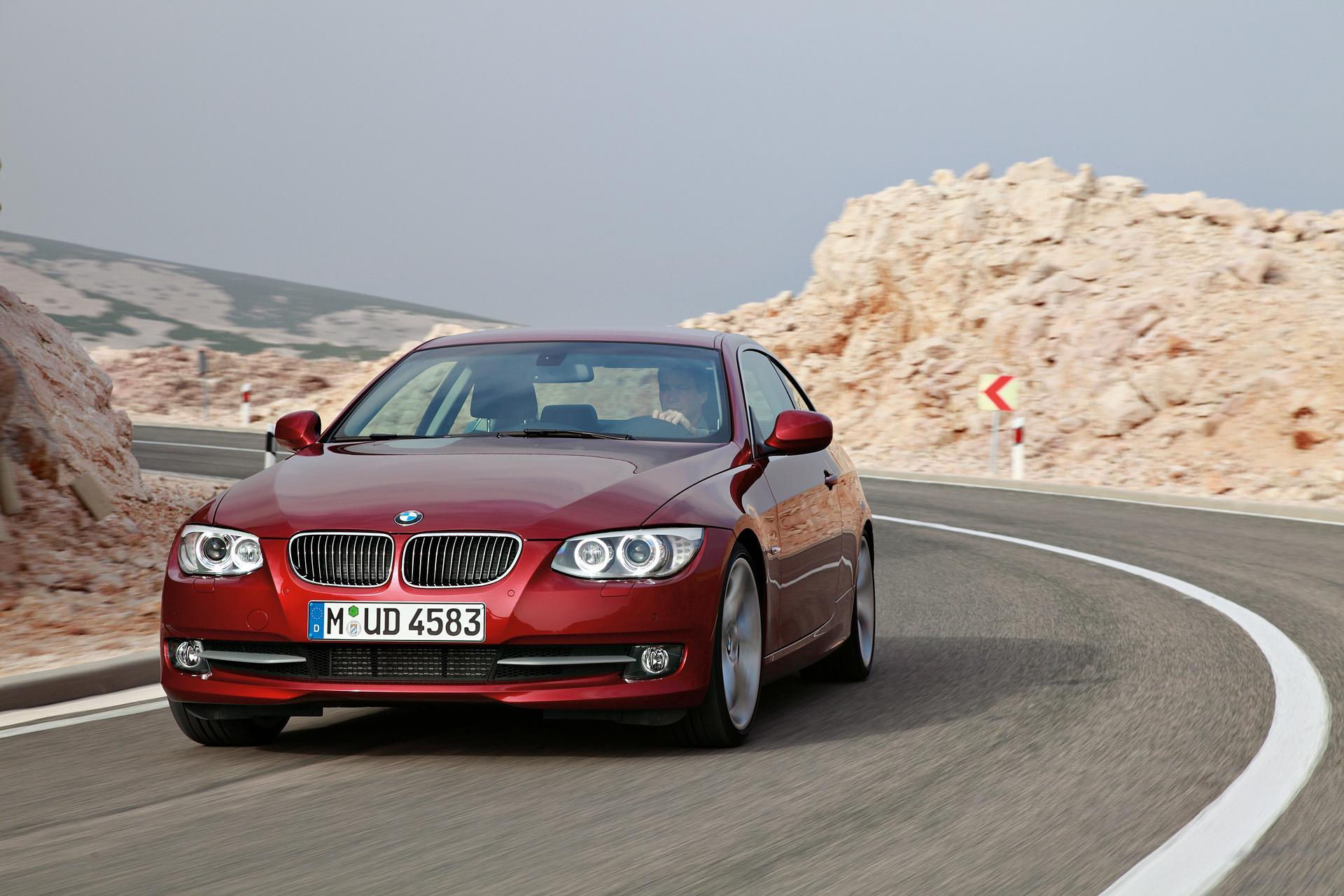 Wallpaper #lUW_oo4B7YBJg1BVBqSA38 A Red BMW 3 Series Coupe Drives on a Winding Road