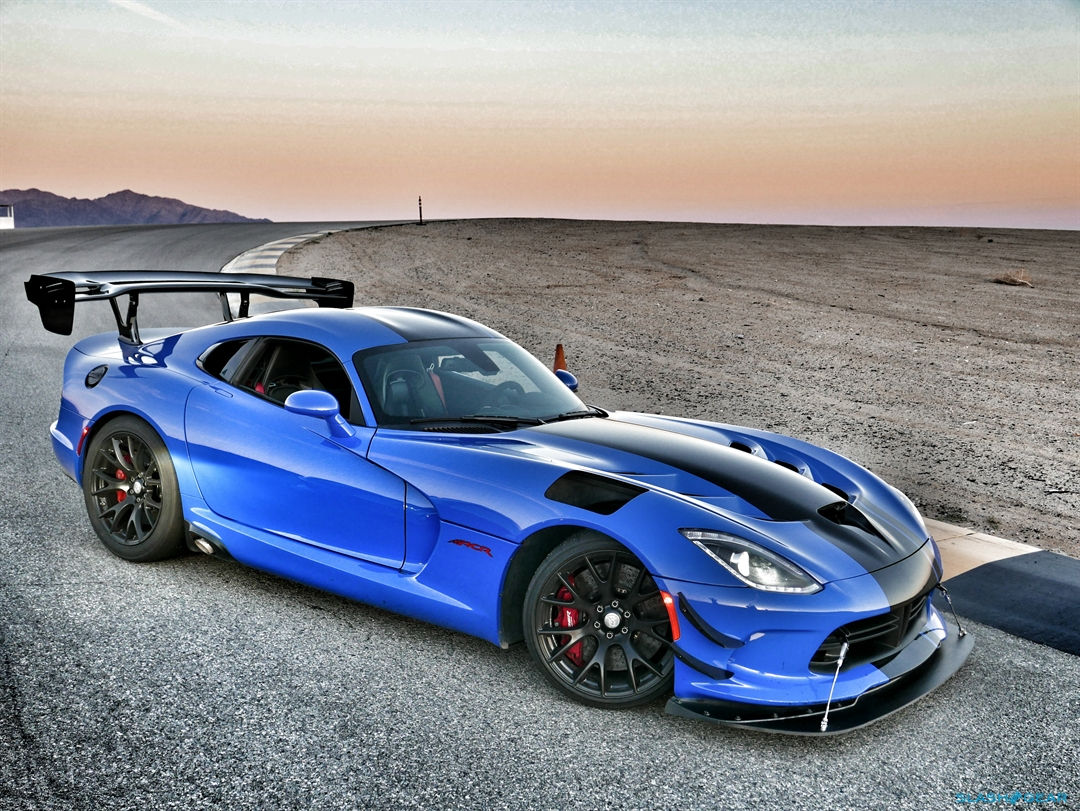 Wallpaper #-BWPso4BmMigT4UnP1FC8 A Blue Sports Car Parked on a Desert Road