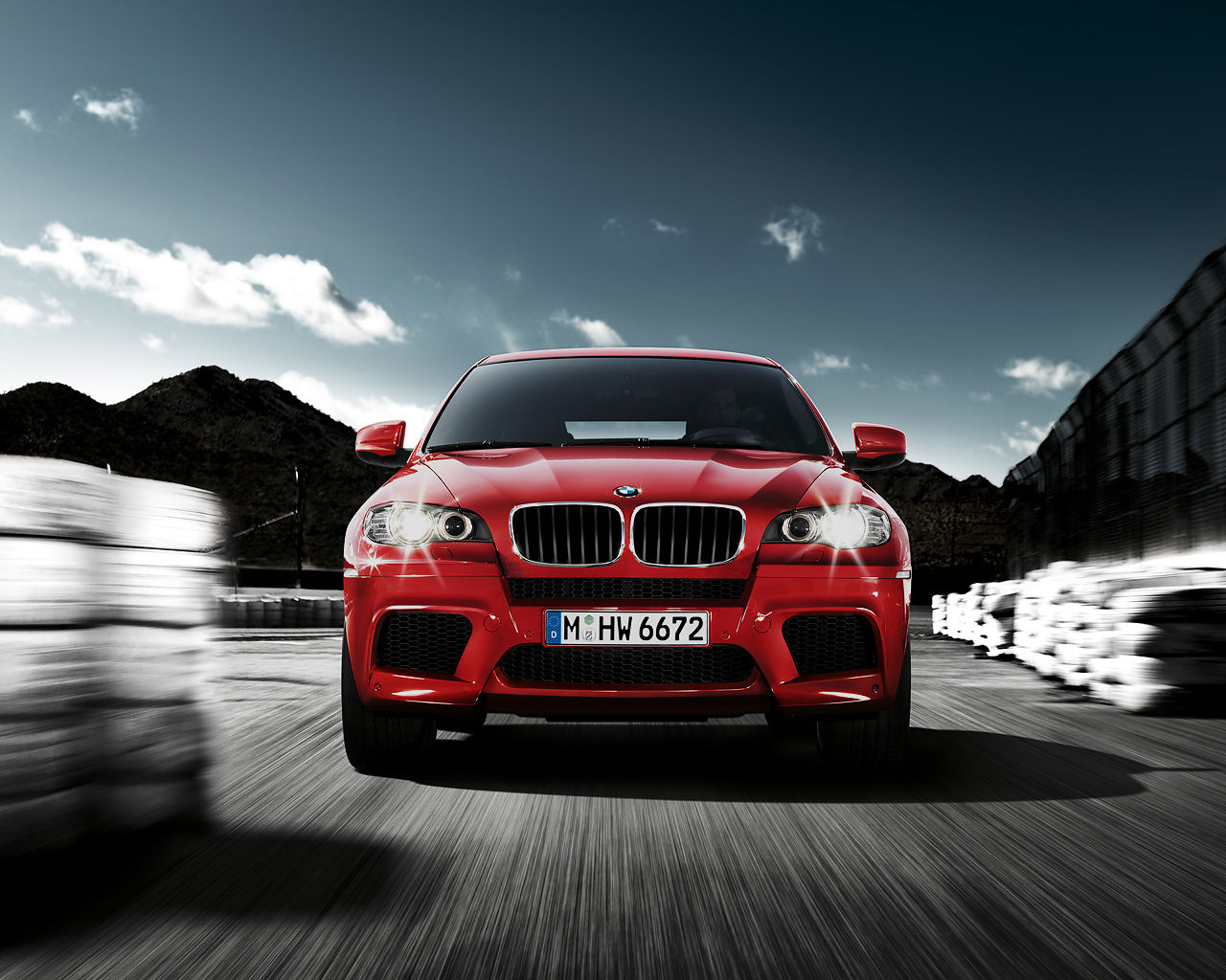 Wallpaper #w0Xoko4B7YBJg1BVD55I41 A Red BMW X6m Driving on a Track