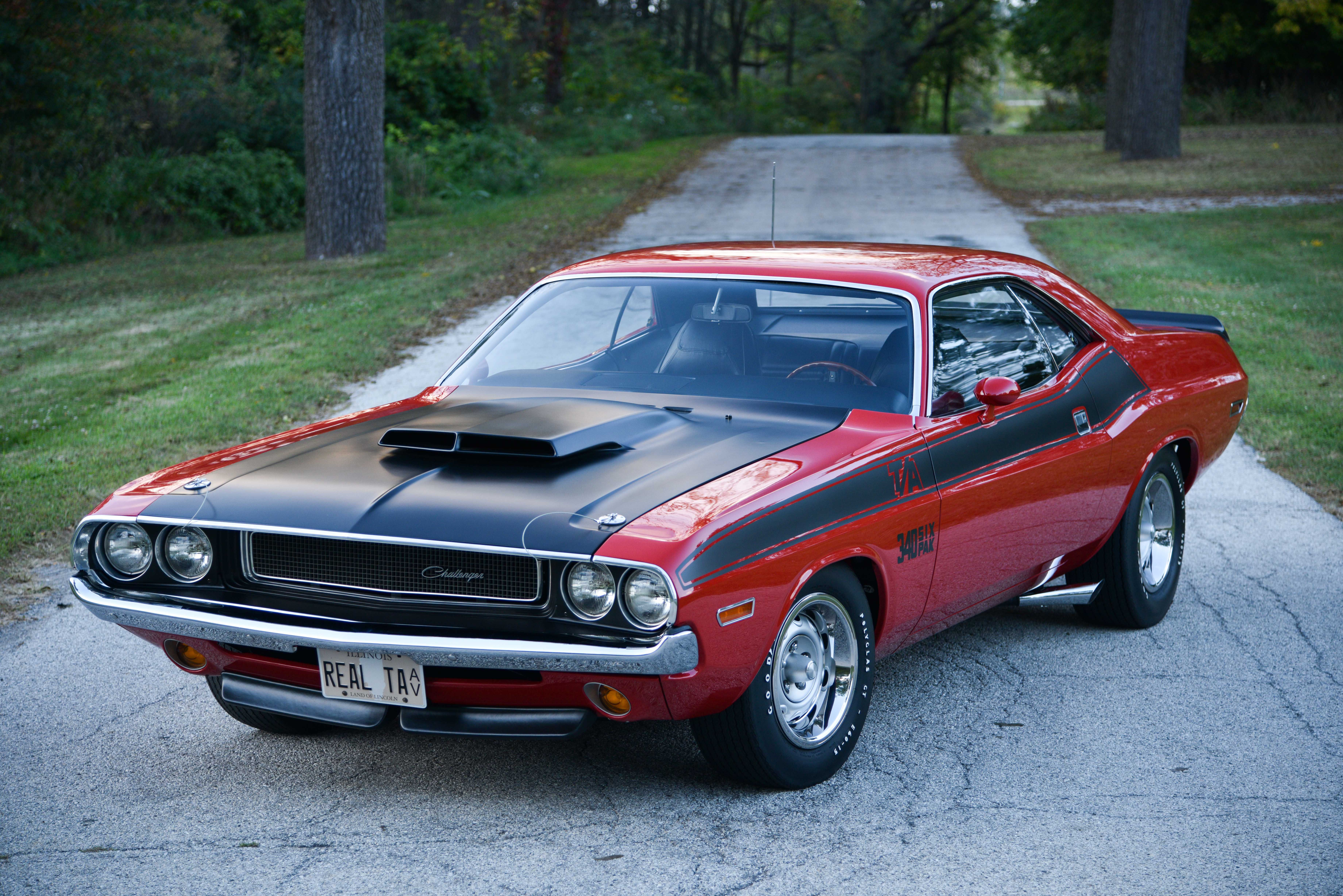 Wallpaper #ZHMQg44BFI5NbQks_xk220 A Red 1970 Plymouth Barracuda with a Black Hood Parked on a Country Road