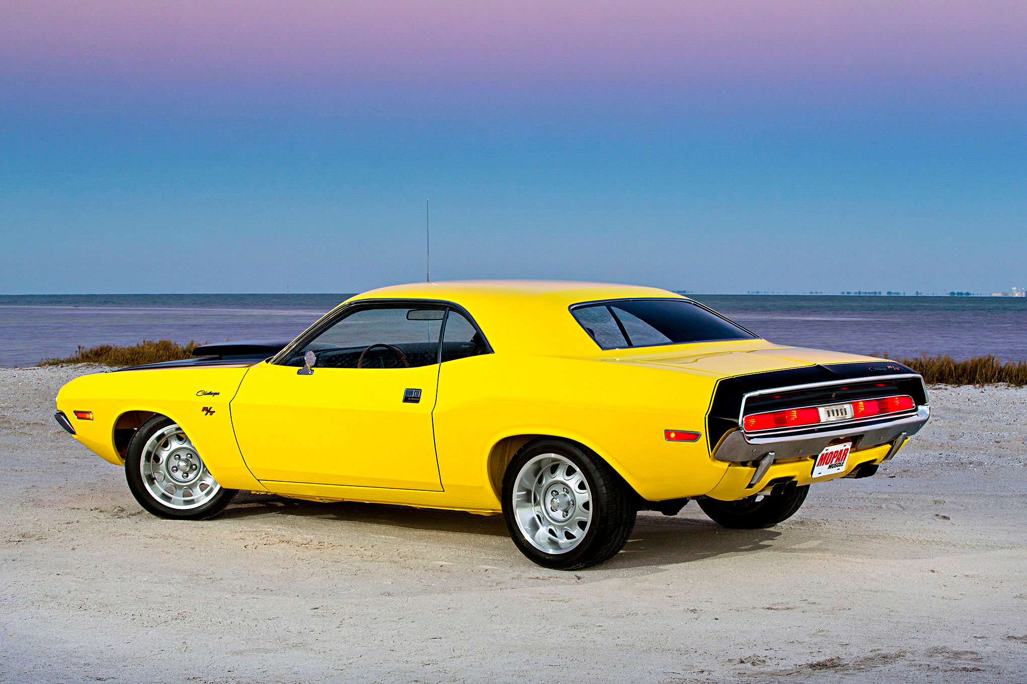 Wallpaper #ZHMQg44BFI5NbQks_xk223 A Yellow 1970s Dodge Challenger Parked on a Beach