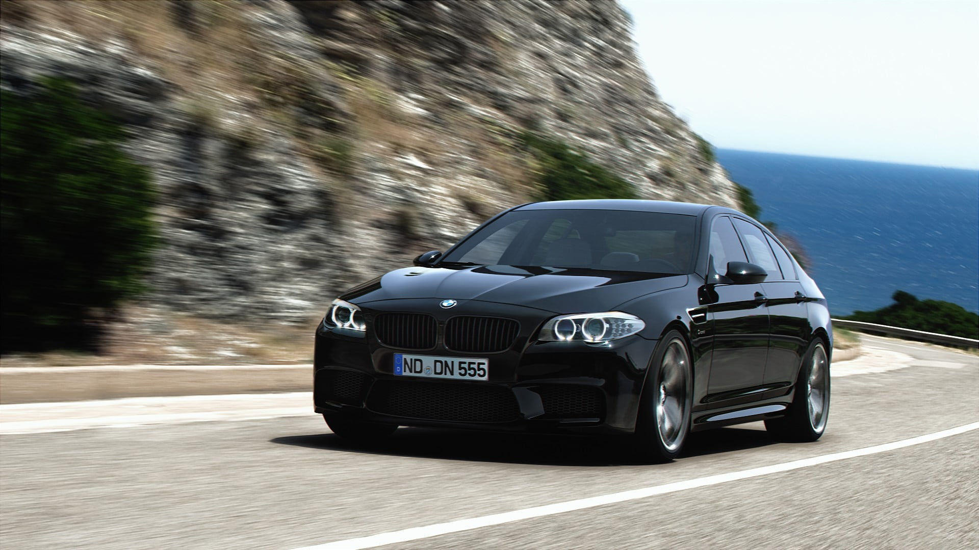 Wallpaper #z0X9ko4B7YBJg1BVTJ5P53 Black BMW M5 Speeding on a Coastal Road