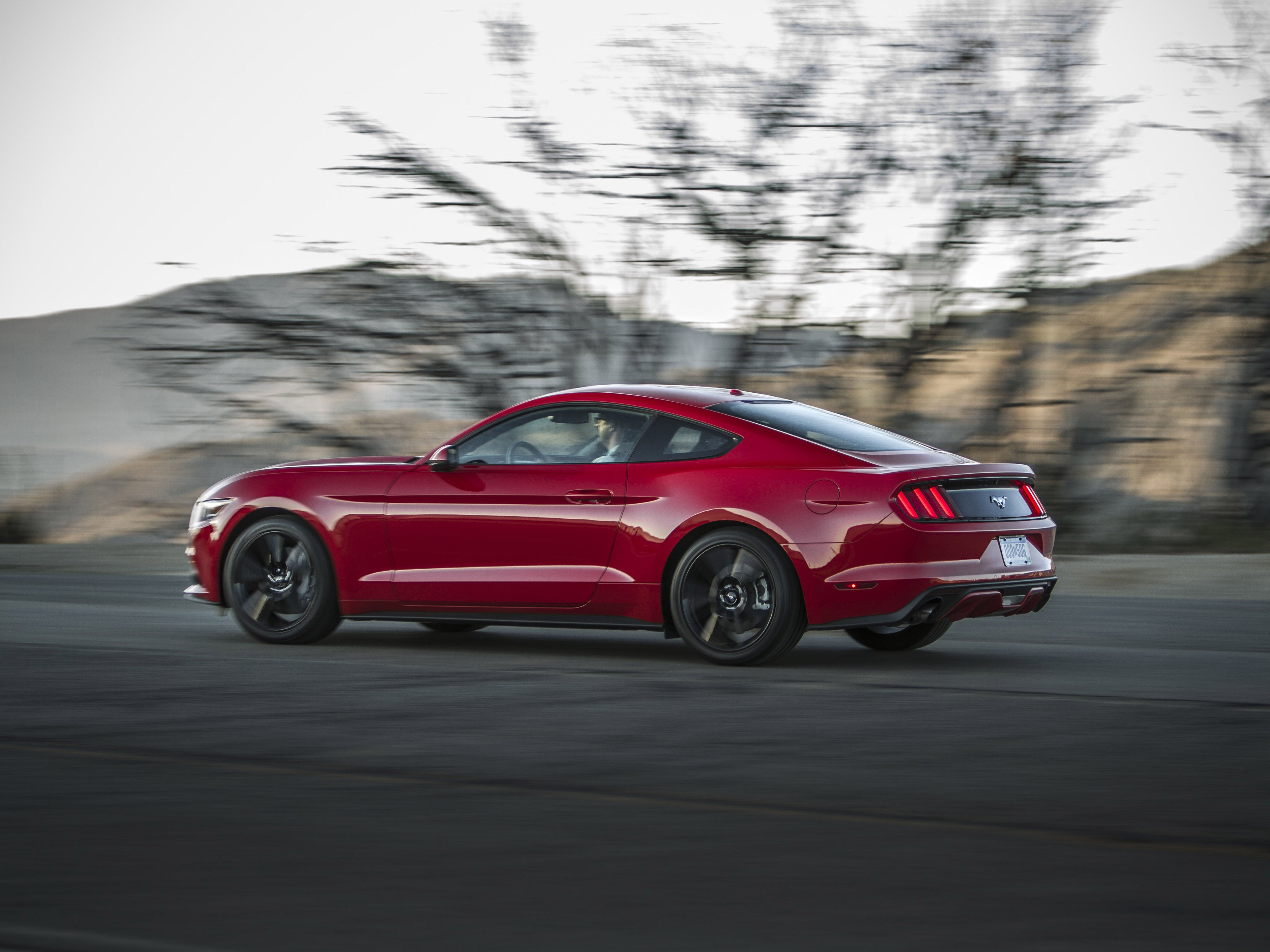 Wallpaper #_kWjoY4B7YBJg1BVvqN859 A Red Ford Mustang GT Fastback Driving on a Winding Road